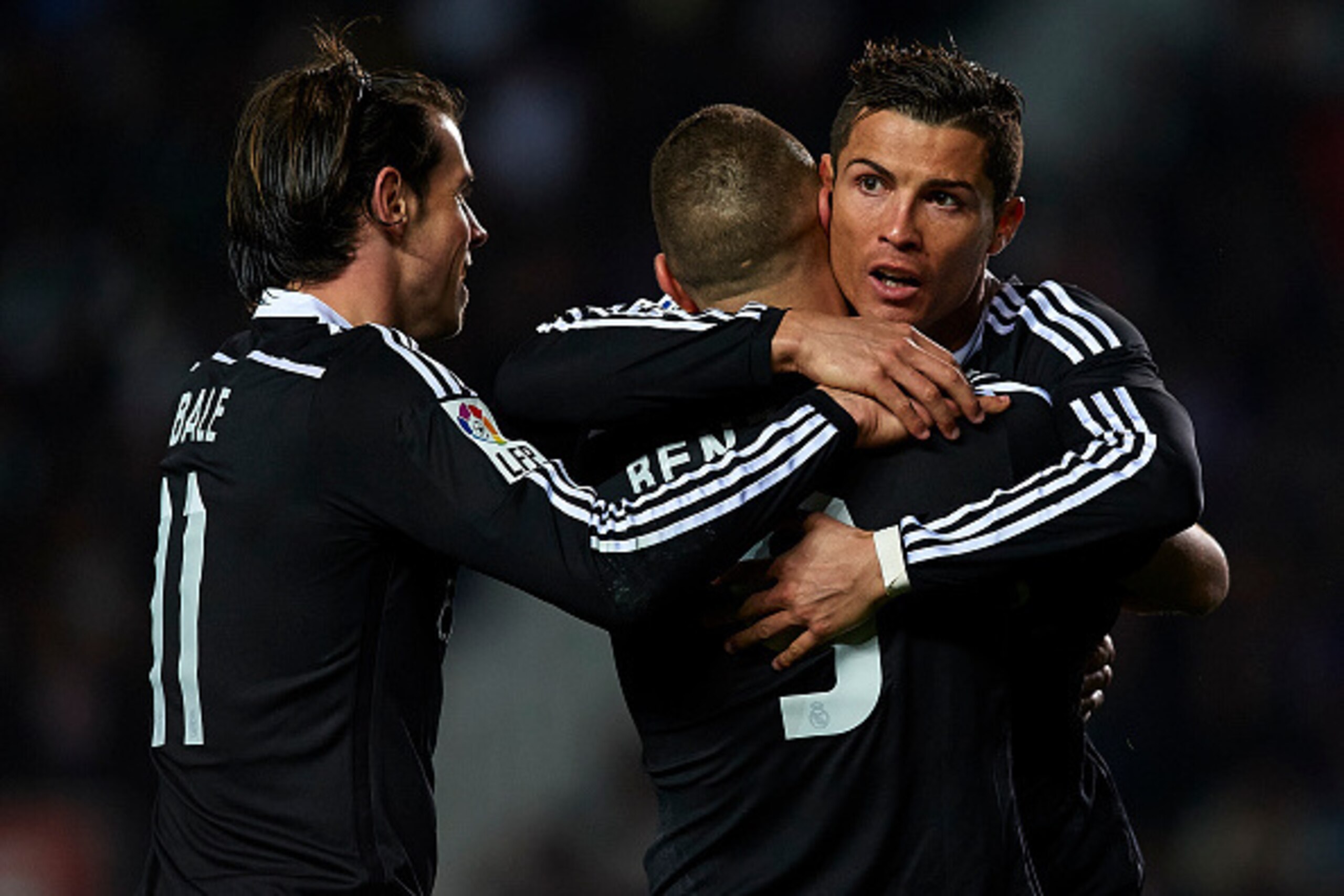 ELCHE, SPAIN - FEBRUARY 22:  Karim Benzema of Real Madrid celebrates after scoring with his teammates Cristiano Ronaldo (R) and Gareth Bale during the La Liga match between Elche FC and Real Madrid at Estadio Manuel Martinez Valero on February 22, 2015 in