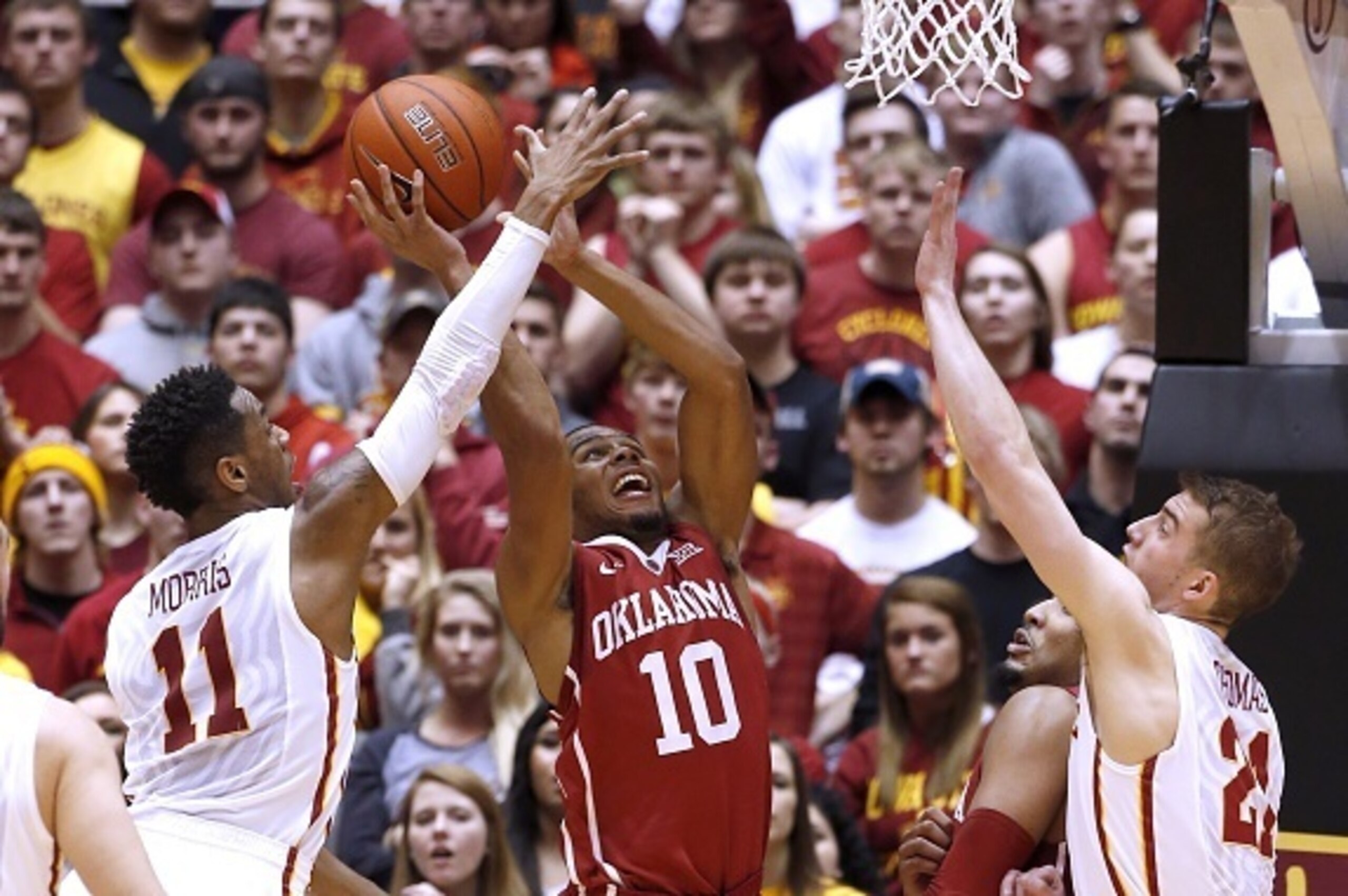 AMES, IA - MARCH 2: Jordan Woodard #10 of the Oklahoma Sooners takes a shot as Monte Morris #11, and Matt Thomas #21 of the Iowa State Cyclones block in the first half of play at Hilton Coliseum on March 2, 2015 in Ames, Iowa. (Photo by David Purdy/Getty 