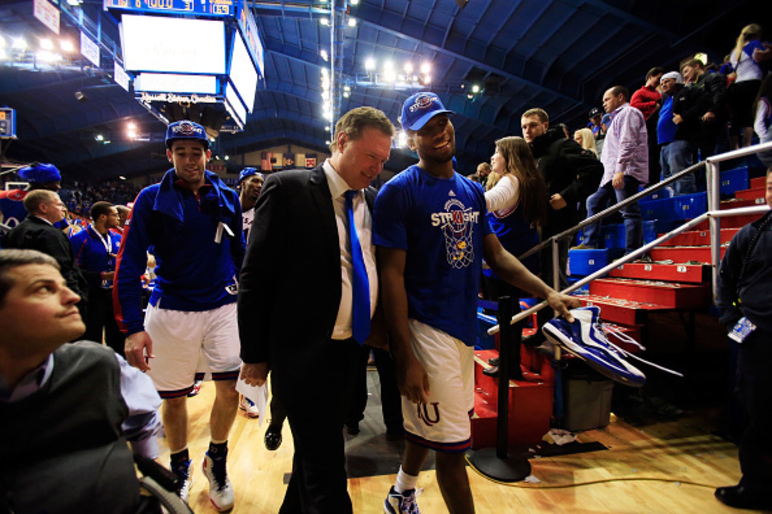 LAWRENCE, KS - MARCH 03:  Head coach Bill Self of the Kansas Jayhawks walks off the court with Wayne Selden Jr. #1  after the Jayhawks defeated the West Virginia Mountaineers 76-69 in overtime to win the game and clinch their eleventh straight Big IX Cham