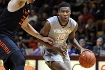 Mar 7, 2015; Blacksburg, VA, USA; Virginia Tech Hokies guard Justin Bibbs (10) dribbles while being defended by Miami Hurricanes forward Ivan Cruz Uceda (33) in the second half at Cassell Coliseum. Miami defeated Virginia Tech 82-61. Mandatory Credit: Mic