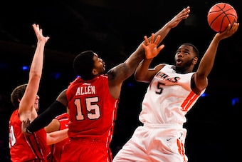NEW YORK, NY - DECEMBER 20: Stacy Davis #5 of the Pepperdine Waves attempts a shot over T.J. Cline #10 and Terry Allen #15 of the Richmond Spiders in the second half of the Gotham Classic at Madison Square Garden on December 20, 2014 in New York City.  (P