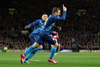 MANCHESTER, ENGLAND - MARCH 09:  Nacho Monreal (L) of Arsenal celebrates after scoring the opening goal with teammate Alex Oxlade-Chamberlain of Arsenal during the FA Cup Quarter Final match between Manchester United and Arsenal at Old Trafford on March 9