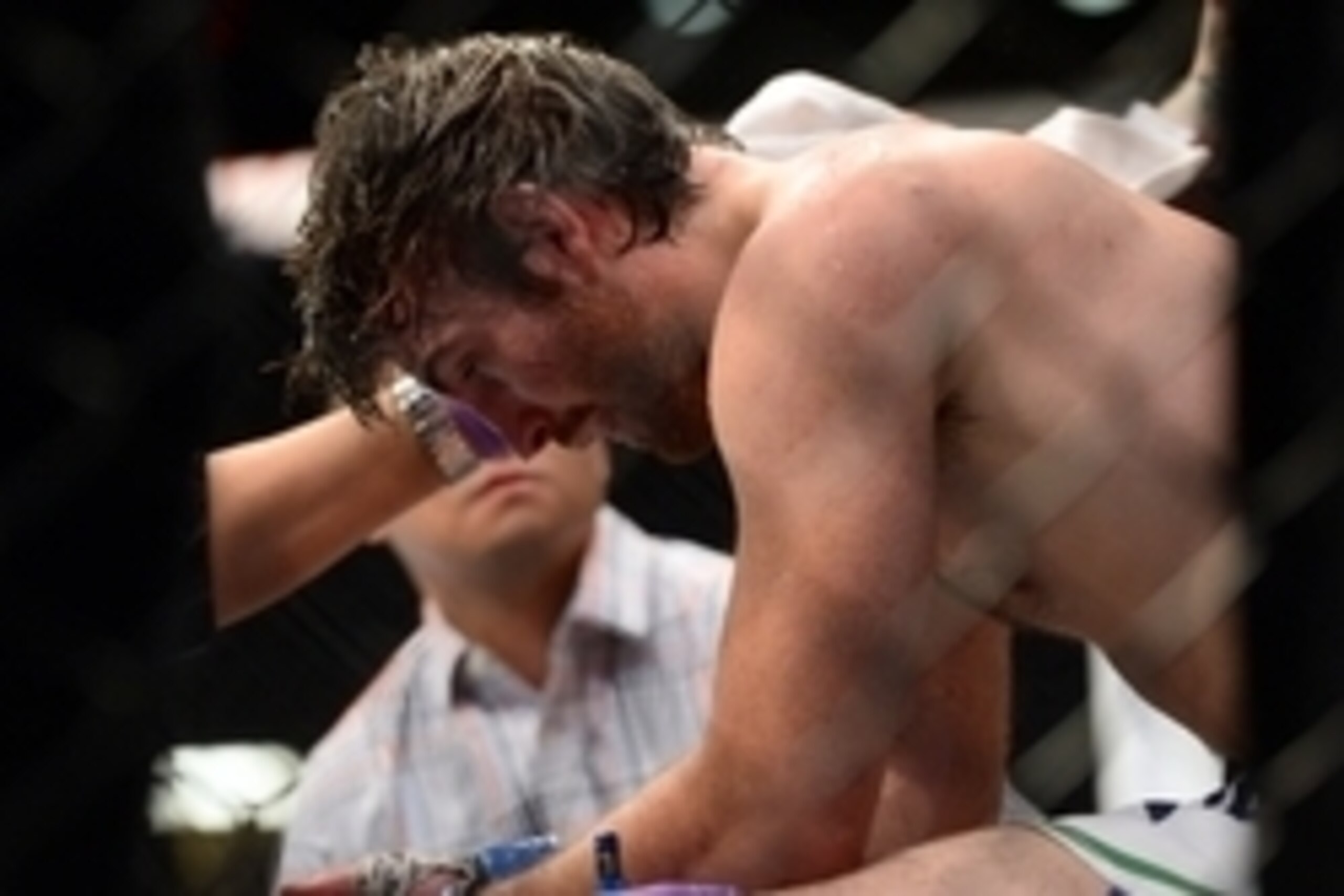 Jun 7, 2014; Albuquerque, NM, USA; Jake Lindsey (blue) is tended to after his lightweight bout against Jon Tuck (red) during UFC Fight Night 42 at Tingley Coliseum. Tuck won via second round submission. Mandatory Credit: Joe Camporeale-USA TODAY Sports
