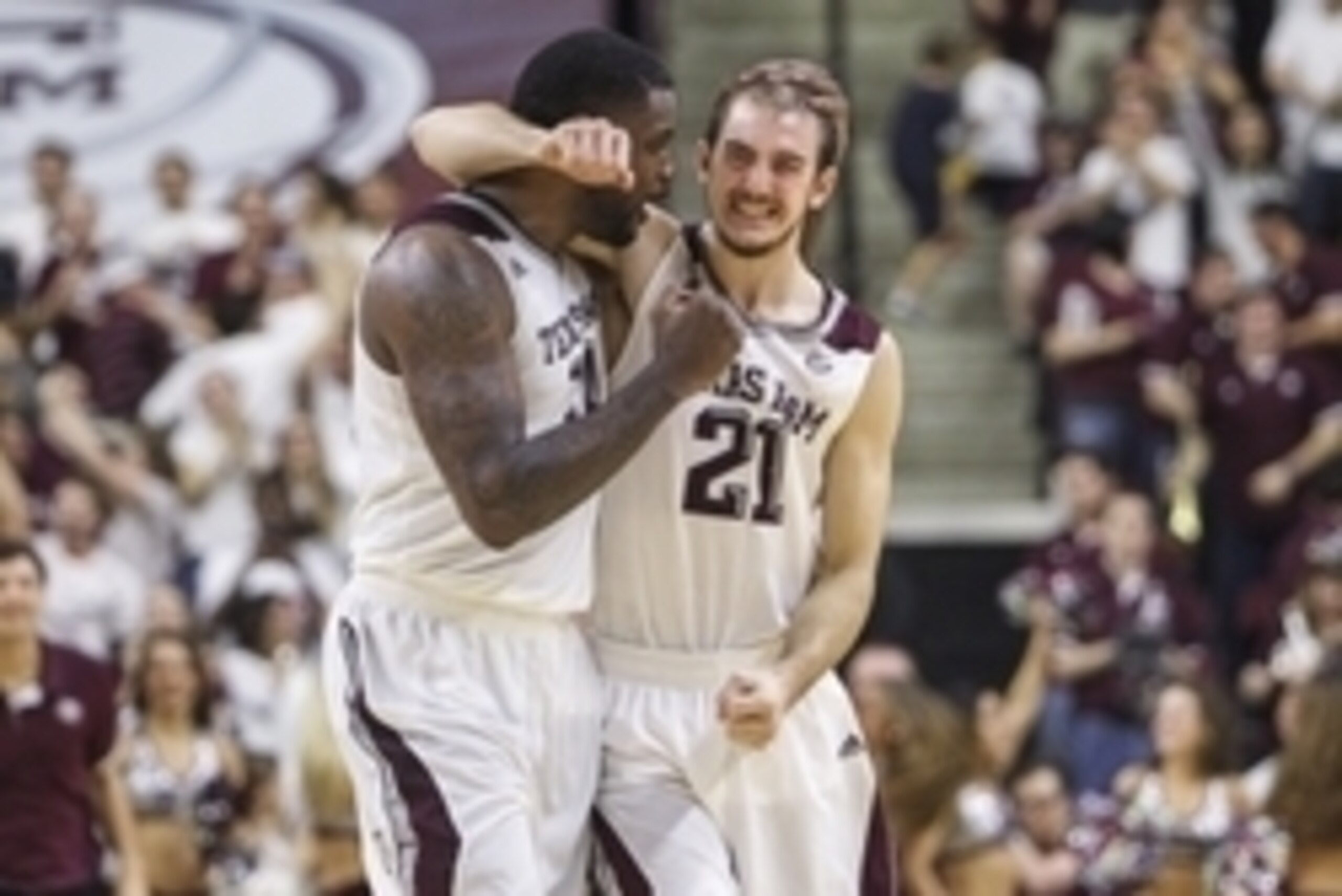 Feb 14, 2015; College Station, TX, USA; Texas A&M Aggies forward Kourtney Roberson (14) and guard Alex Caruso (21) celebrate after the Aggies defeated the Florida Gators 63-62 at Reed Arena. Mandatory Credit: Troy Taormina-USA TODAY Sports