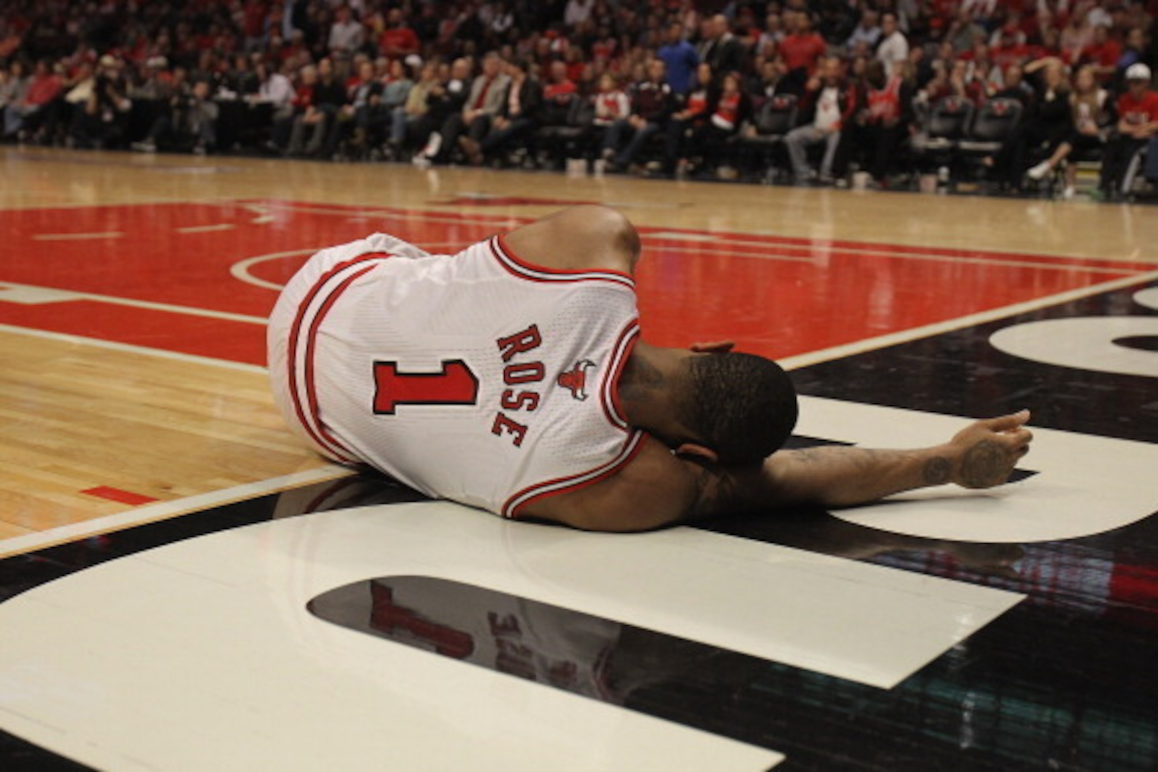 CHICAGO, IL - APRIL 28: Derrick Rose #1 of the Chicago Bulls lays on the floor aftrer suffering an injury against the Philadelphia 76ers in Game One of the Eastern Conference Quarterfinals during the 2012 NBA Playoffs at the United Center on April 28, 201