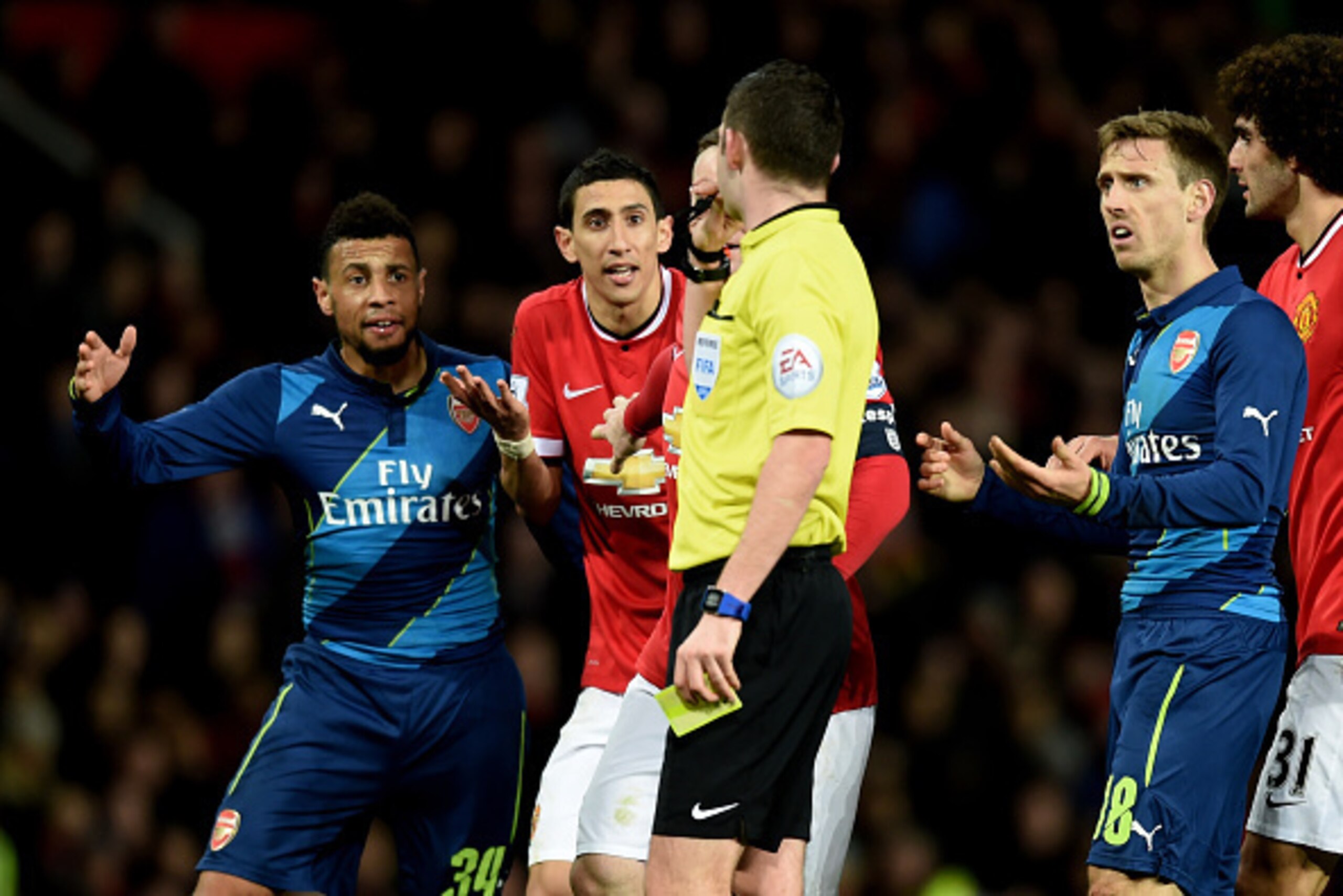 MANCHESTER, ENGLAND - MARCH 09:  Angel di Maria of Manchester United remonstrates with referee Michael Oliver after he receives the yellow card during the FA Cup Quarter Final match between Manchester United and Arsenal at Old Trafford on March 9, 2015 in