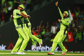 AUCKLAND, NEW ZEALAND - MARCH 07: Mohammad Irfan of Pakistan celebrates with Umar Akmal and Ahmed Shehzad after dismissing Jean-Paul Duminy of South Africa during the 2015 ICC Cricket World Cup match between South Africa and Pakistan at Eden Park on March