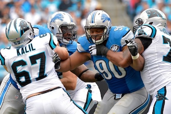 CHARLOTTE, NC - SEPTEMBER 14:  Ndamukong Suh #90 of the Detroit Lions pass rushes against Ryan Kalil #67 of the Carolina Panthers during their game at Bank of America Stadium on September 14, 2014 in Charlotte, North Carolina. The Panthers won 24-7.  (Pho