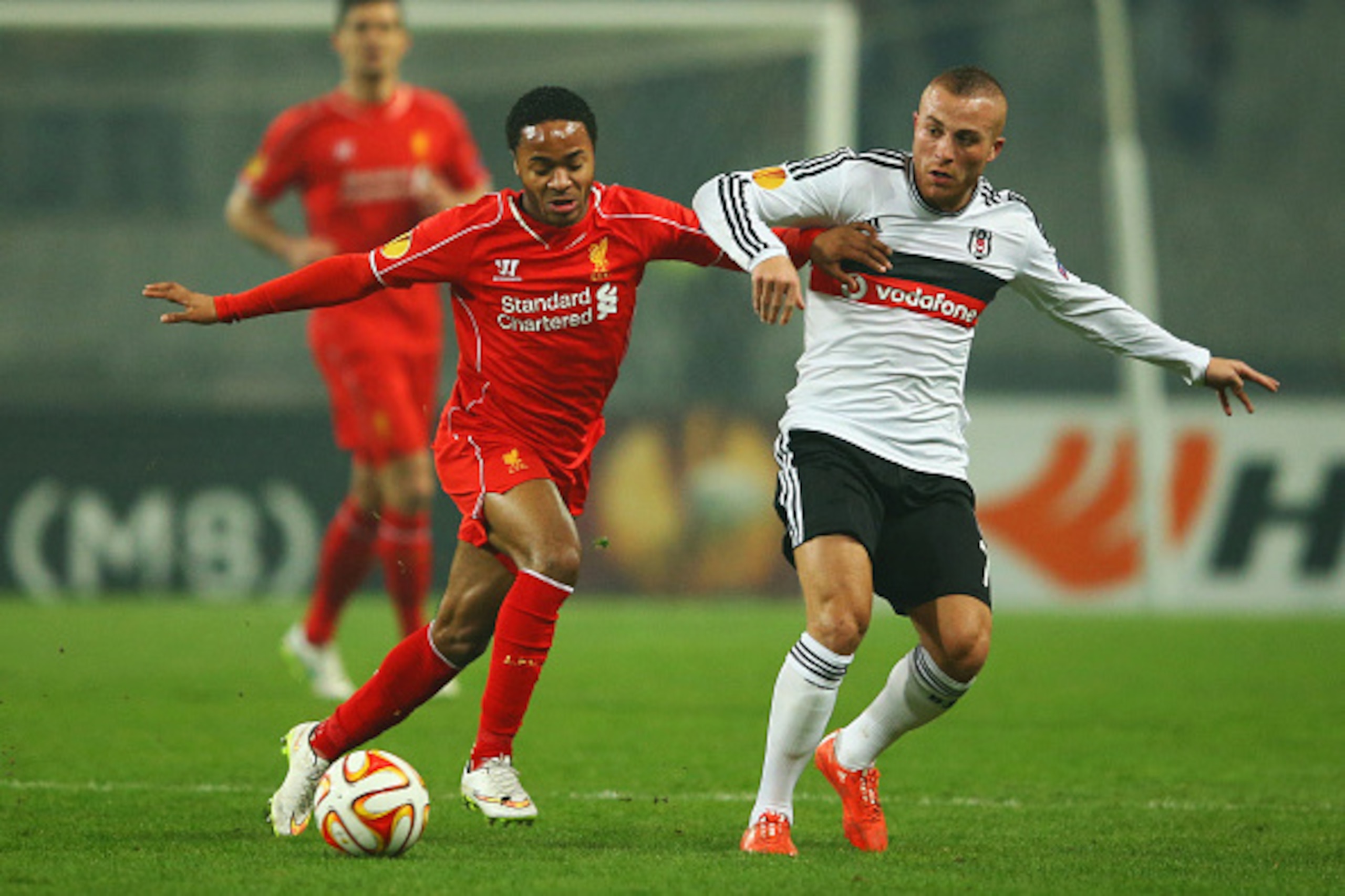 ISTANBUL, TURKEY - FEBRUARY 26:  Raheem Sterling of Liverpool battles with Gokhan Tore of Besiktas during the UEFA Europa League Round of 32 second leg match between Besiktas JK and Liverpool FC on February 26, 2015 in Istanbul, Turkey.  (Photo by Richard