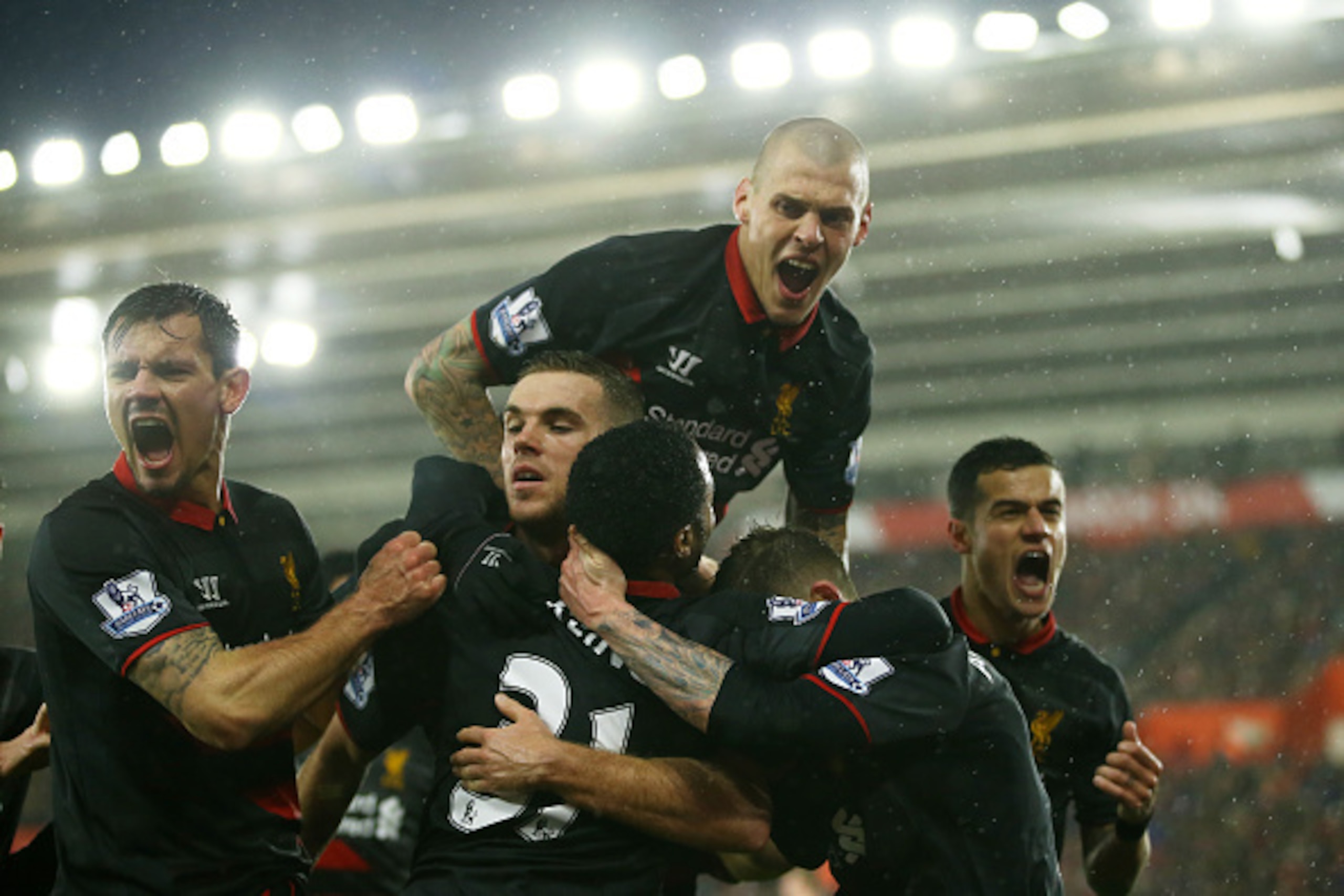 SOUTHAMPTON, ENGLAND - FEBRUARY 22:  Raheem Sterling #31 (C) of Liverpool is congratulated by teammates after scoring his team's second goal during the Barclays Premier League match between Southampton and Liverpool at St Mary's Stadium on February 22, 20