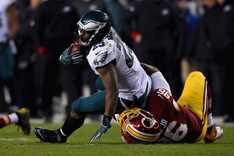 LANDOVER, MD - DECEMBER 20: Running back LeSean McCoy #25 of the Philadelphia Eagles is tackled by nose tackle Barry Cofield #96 of the Washington Redskins in the first quarter of a game at FedExField on December 20, 2014 in Landover, Maryland.  (Photo by
