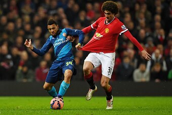 MANCHESTER, ENGLAND - MARCH 09:  Francis Coquelin of Arsenal is challenged by Marouane Fellaini of Manchester United during the FA Cup Quarter Final match between Manchester United and Arsenal at Old Trafford on March 9, 2015 in Manchester, England.  (Pho