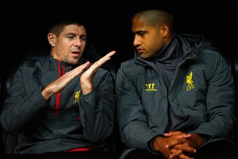 MADRID, SPAIN - NOVEMBER 04:  (L-R) Steven Gerrard. Glen Johnson of Liverpool talk as they sit on substitute the bench during the UEFA Champions League Group B match between Real Madrid CF and Liverpool FC at Estadio Santiago Bernabeu on November 4, 2014 