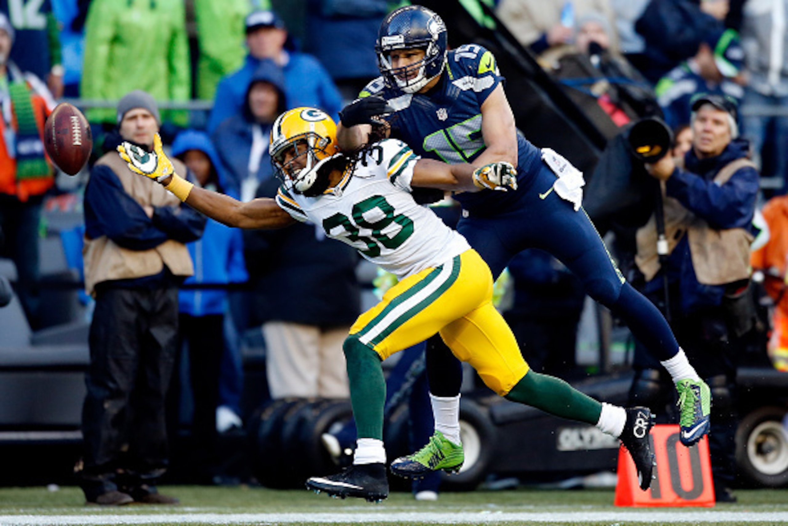 SEATTLE, WA - JANUARY 18: Tramon Williams #38 of the Green Bay Packers and  Jermaine Kearse #15 of the Seattle Seahawks go after a pass during the second half of the 2015 NFC Championship game at CenturyLink Field on January 18, 2015 in Seattle, Washingto