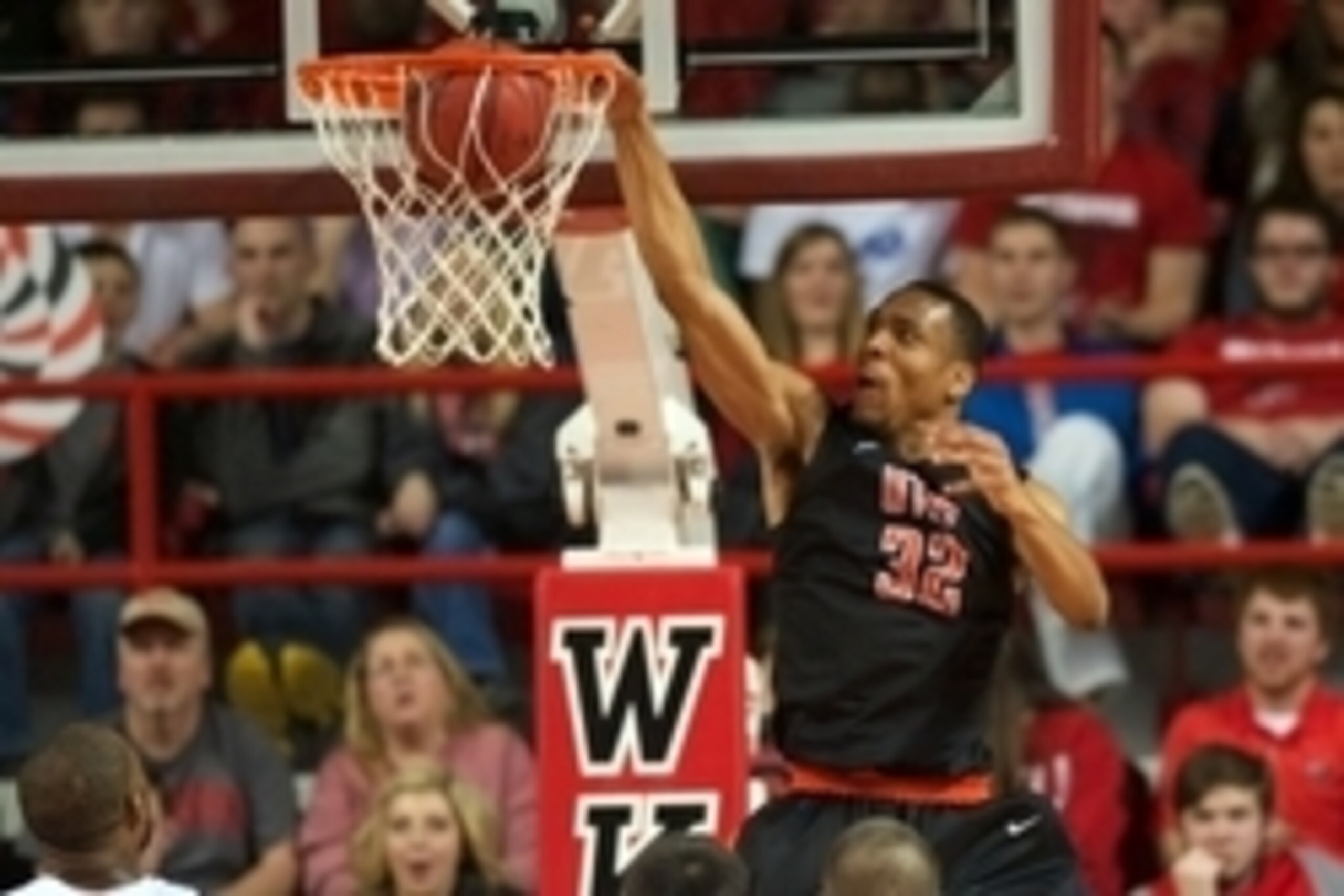 Jan 22, 2015; Bowling Green, KY, USA; UTEP Miners forward Vince Hunter (32) dunks the ball over Western Kentucky Hilltoppers forward George Fant (44) and forward Aleksej Rostov (20) and guard Chris Harrison-Docks (51) during the second half at E.A. Diddle