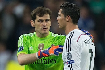 MADRID, SPAIN - MARCH 10: goalkeeper Iker Casillas (L) of Real Madrid CF holds his teammate Cristiano Ronaldo (R) after loosing the UEFA Champions League round of 16 second leg match between Real Madrid CF and FC Schalke 04 at Estadio Santiago Bernabeu on