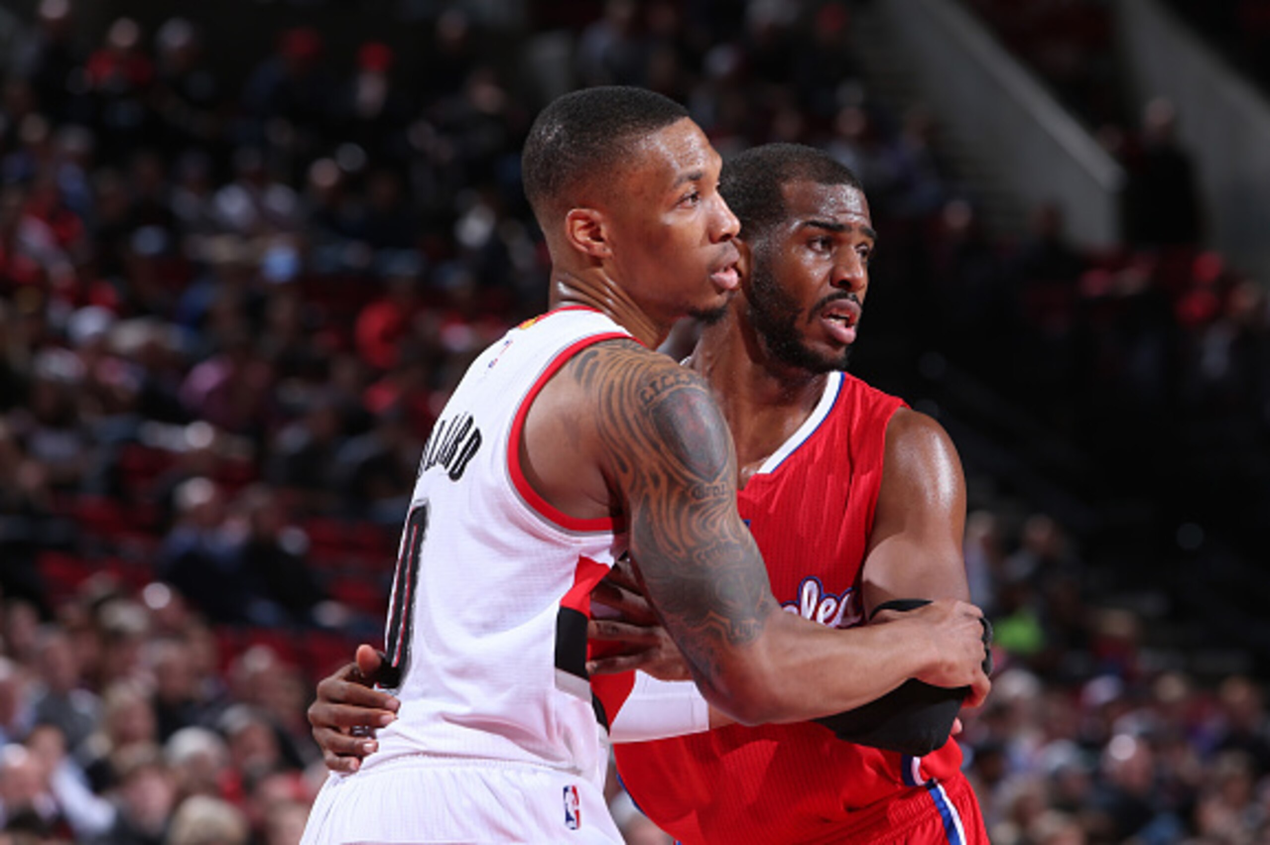 PORTLAND, OR - JANUARY 14:  Chris Paul #3 of the Los Angeles Clippers and Damian Lillard #0 of the Portland Trail Blazers stand on the court on January 14, 2015 at the Moda Center Arena in Portland, Oregon. NOTE TO USER: User expressly acknowledges and ag