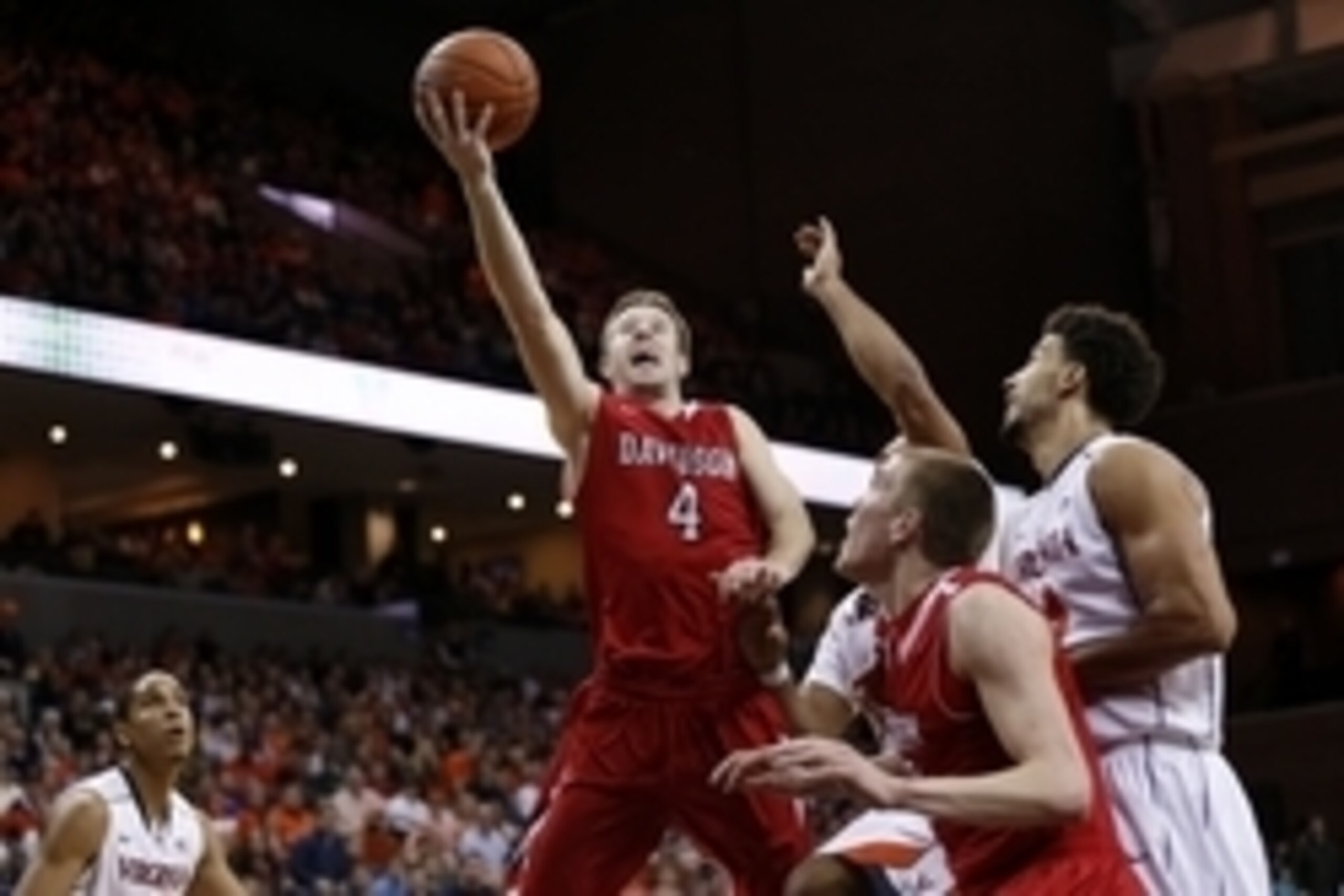 Dec 30, 2014; Charlottesville, VA, USA; Davidson Wildcats guard Tyler Kalinoski (4) shoots the ball in front of Virginia Cavaliers guard Justin Anderson (1) and Cavaliers forward Anthony Gill (13) in the first half at John Paul Jones Arena. Mandatory Cred