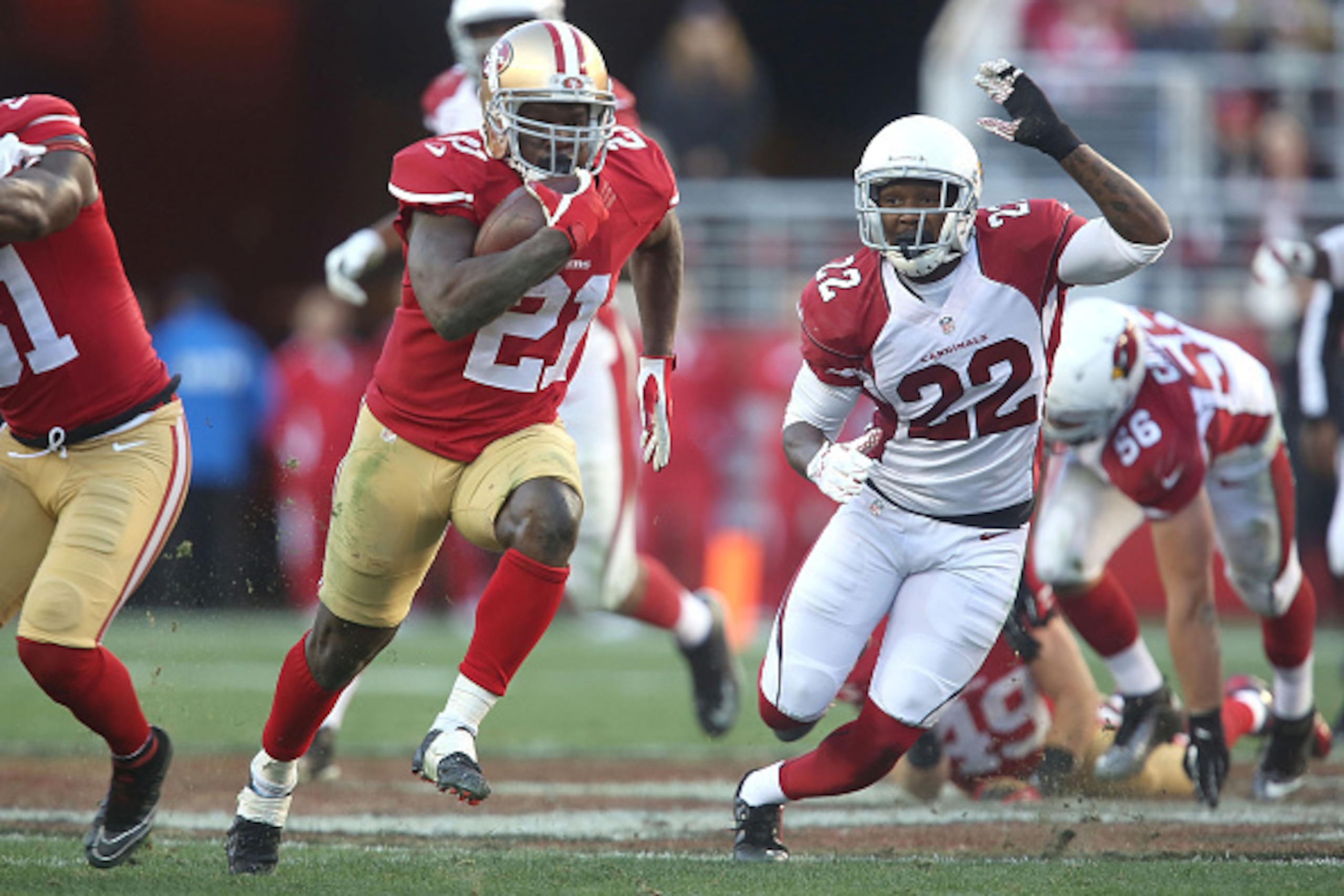 SANTA CLARA, CA - DECEMBER 28: Frank Gore #21 of the San Francisco 49ers drives in front of Tony Jefferson #22 of the Arizona Cardinals in the third quarter at Levi's Stadium on December 28, 2014 in Santa Clara, California. In this play, Gore broke 11,000