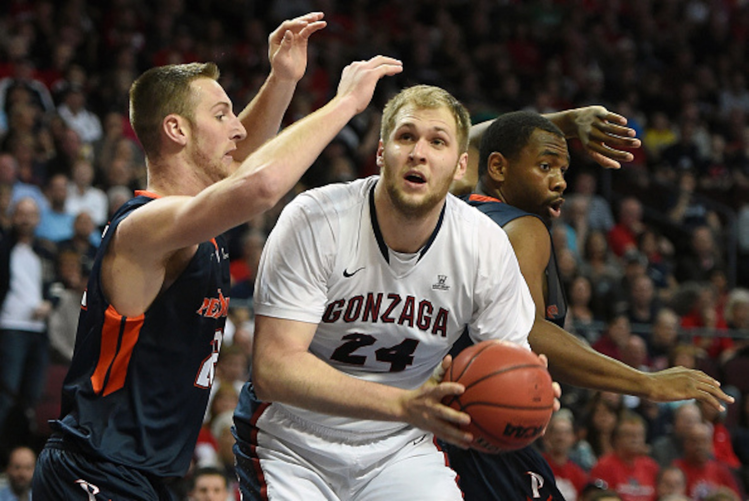 LAS VEGAS, NV - MARCH 09:  Przemek Karnowski #24 of the Gonzaga Bulldogs drives to the basket against Nate Gehring #22 (L) and Stacy Davis #5 of the Pepperdine Waves during a semifinal game of the West Coast Conference Basketball tournament at the Orleans