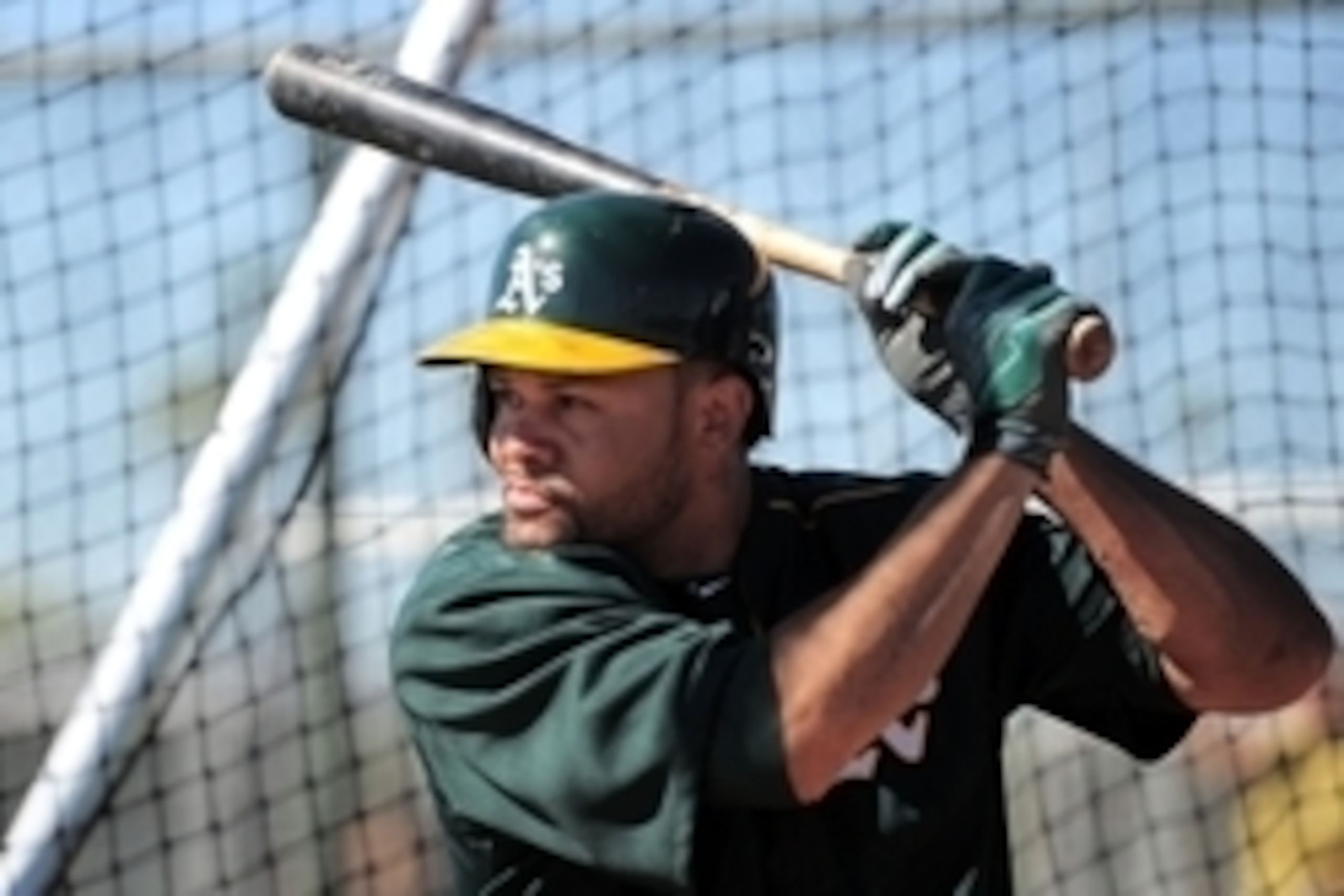 Feb 25, 2015; Mesa, AZ, USA; Oakland Athletics center fielder Coco Crisp (4) bats during a workout at Fitch Park. Mandatory Credit: Joe Camporeale-USA TODAY Sports