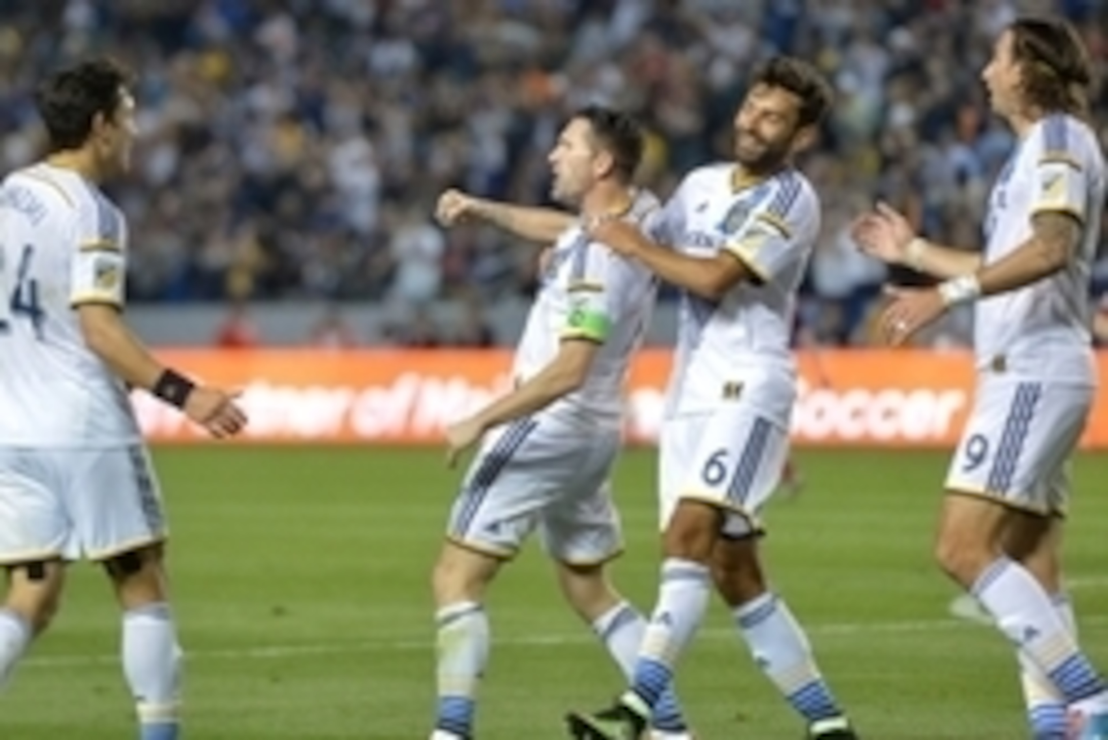 Mar 6, 2015; Carson, CA, USA; Los Angeles Galaxy forward Robbie Keane (7) celebrates with teammates Stefan Ishizaki (24), Baggio Husidic (6) and Alan Gordon (9) after scoring a goal in the second half against the Chicago Fire at StubHub Center. The Galaxy