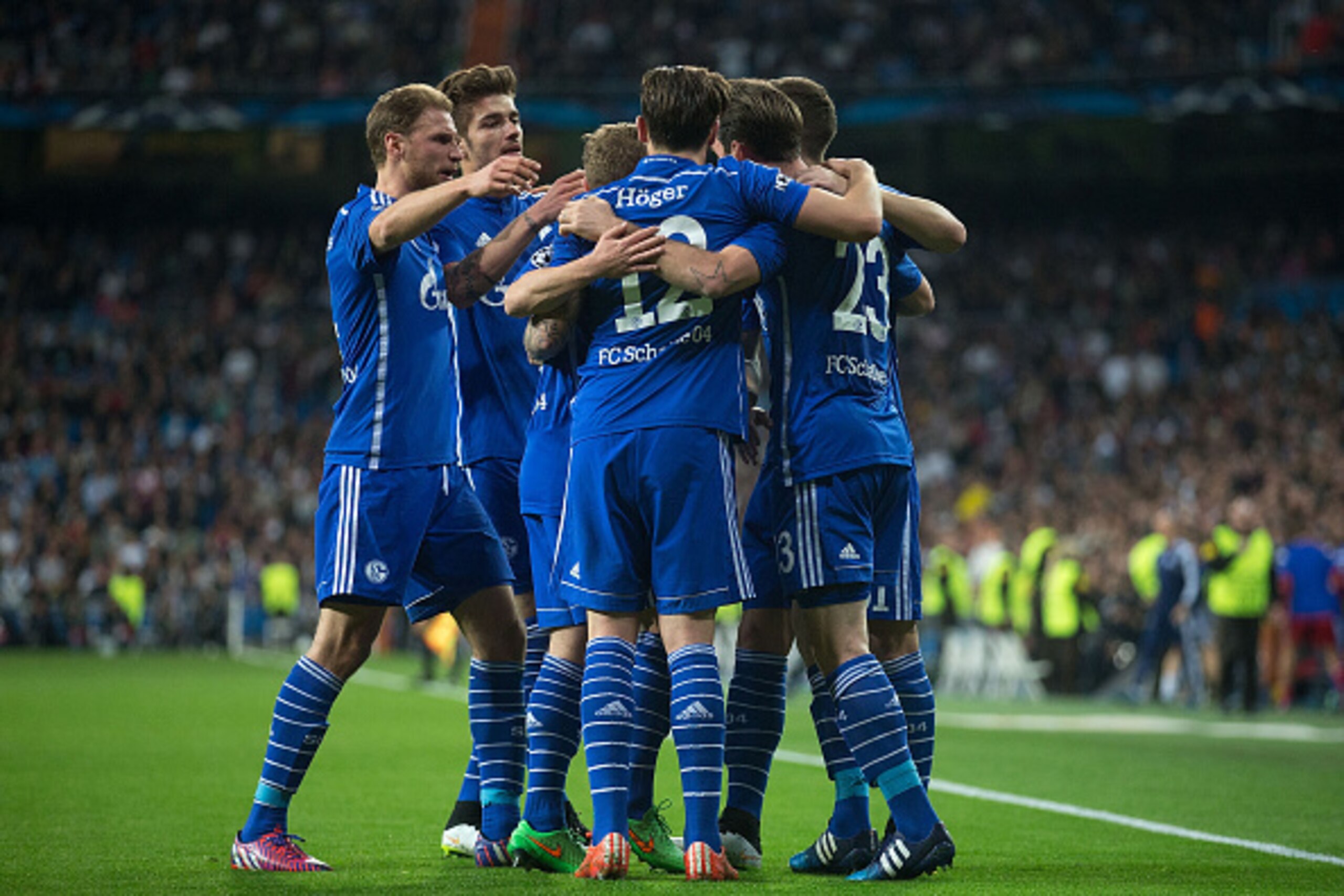 MADRID, SPAIN - MARCH 10:  Christian Fuchs (R) of FC Schalke 04 celebrates scoring their opening goal with teammates during the UEFA Champions League round of 16 second leg match between Real Madrid CF and FC Schalke 04 at Estadio Santiago Bernabeu on Mar