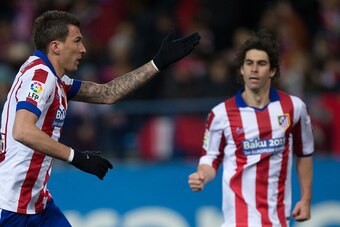 MADRID, SPAIN - FEBRUARY 21: Mario Mandzukic (L) of Atletico de Madrid celebrates scoring their opening goal with teammate Tiago Mendes (L) during the La Liga match between Club Atletico de Madrid and UD Almeria at Vicente Calderon Stadium on February 21,