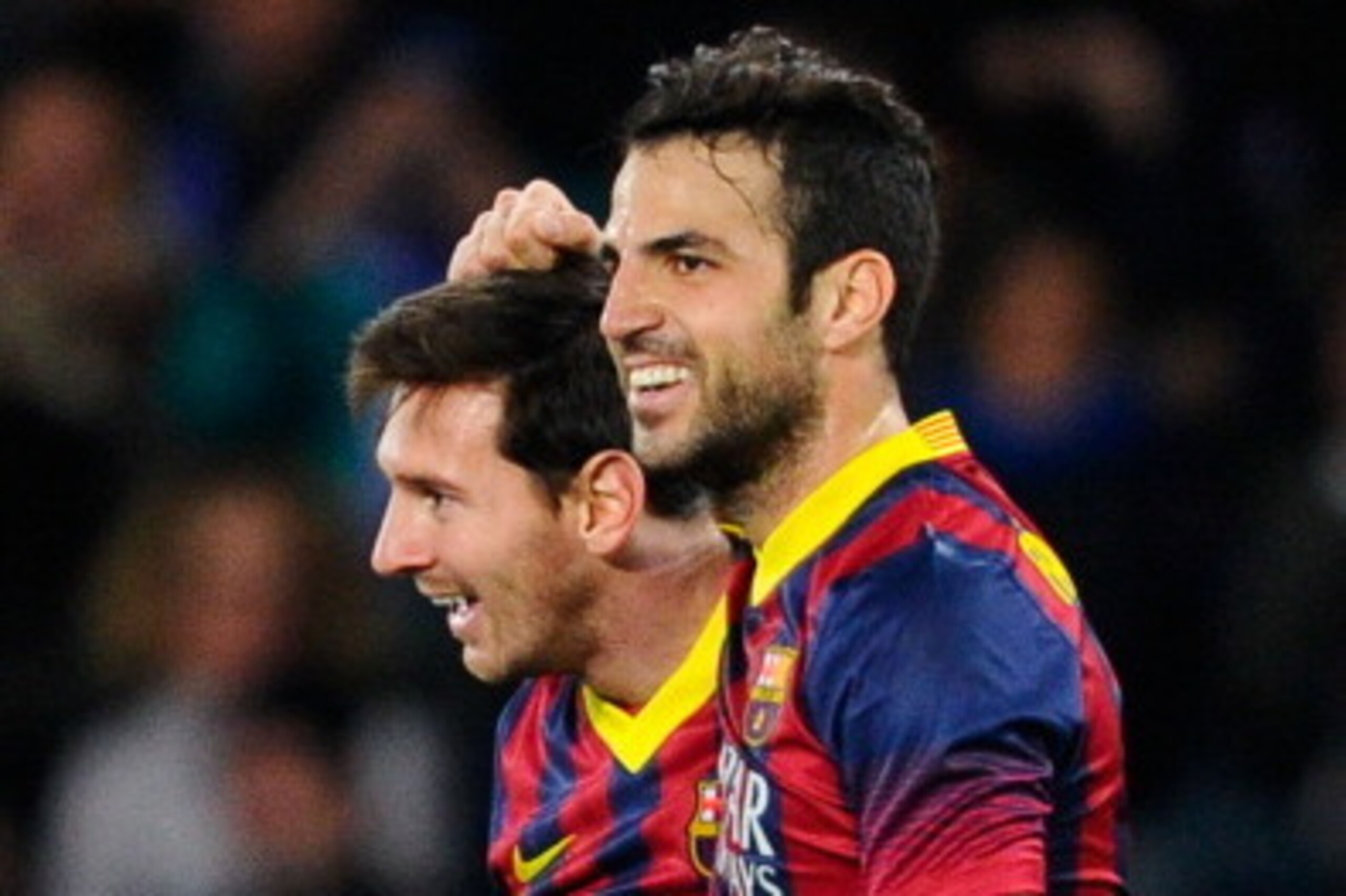 SAN SEBASTIAN, SPAIN - FEBRUARY 12:  Lionel Messi of FC Barcelona celebrates with his teammate Cesc Fabregas after scoring the opening goalduring the Copa del Rey Semi Final second leg between Real Sociedad and FC Barcelona at Anoeta Stadium on February 1
