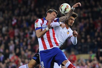 MADRID, SPAIN - MARCH 08:  Mario Mandzukic of Club Atletico de Madrid goes for a high ball against Andre Gomes of  Valencia CF during the Lia Liga match between Club Atletico de Madrid and Valencia CF at Vicente Calderon Stadium on March 8, 2015 in Madrid