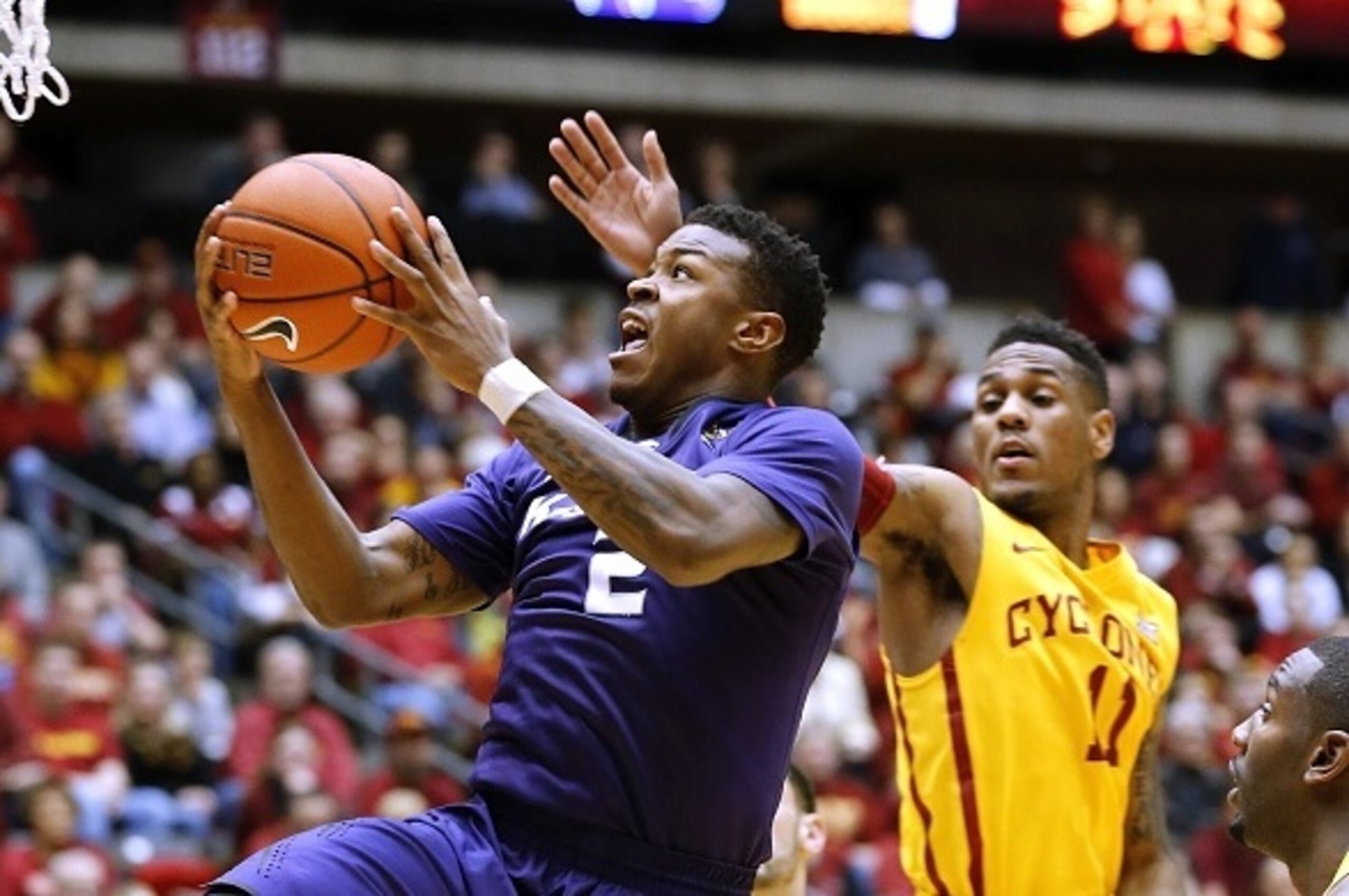 AMES, IA - JANUARY 20:  Marcus Foster #2 of the Kansas State Wildcats takes a shot as Monte Morris #11 of the Iowa State Cyclones blocks in the second half of play at Hilton Coliseum on January 20, 2015 in Ames, Iowa. Iowa State defeated Kansas State 77-7