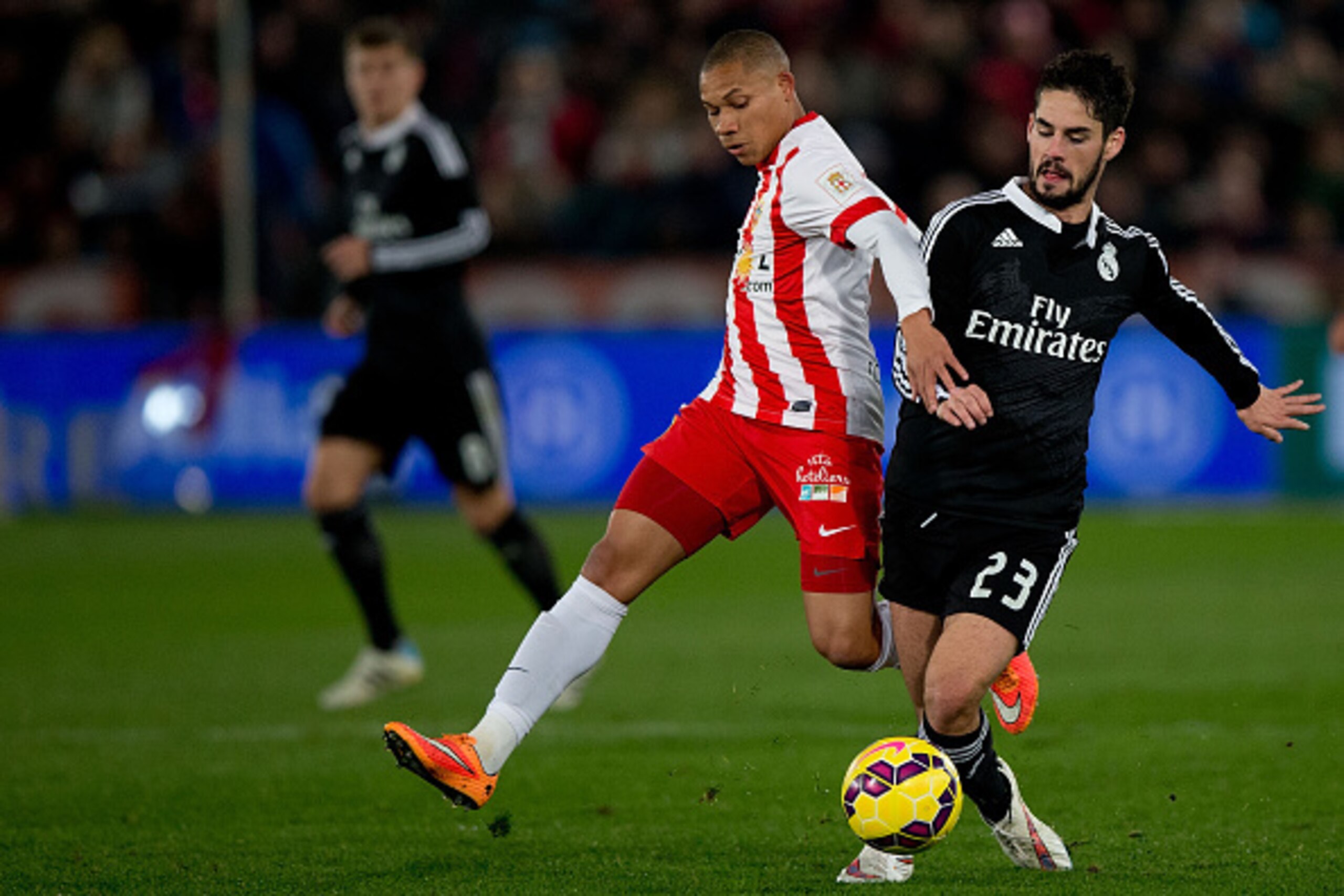ALMERIA, SPAIN - DECEMBER 12: Francisco Roman Alarcon alias Isco (R) of Real Madrid CF competes for the ball with Wellington Silva (L) of Almeria UD during the La Liga match between UD Almeria and Real Madrid CF at Juegos del Mediterraneo stadium on Decem