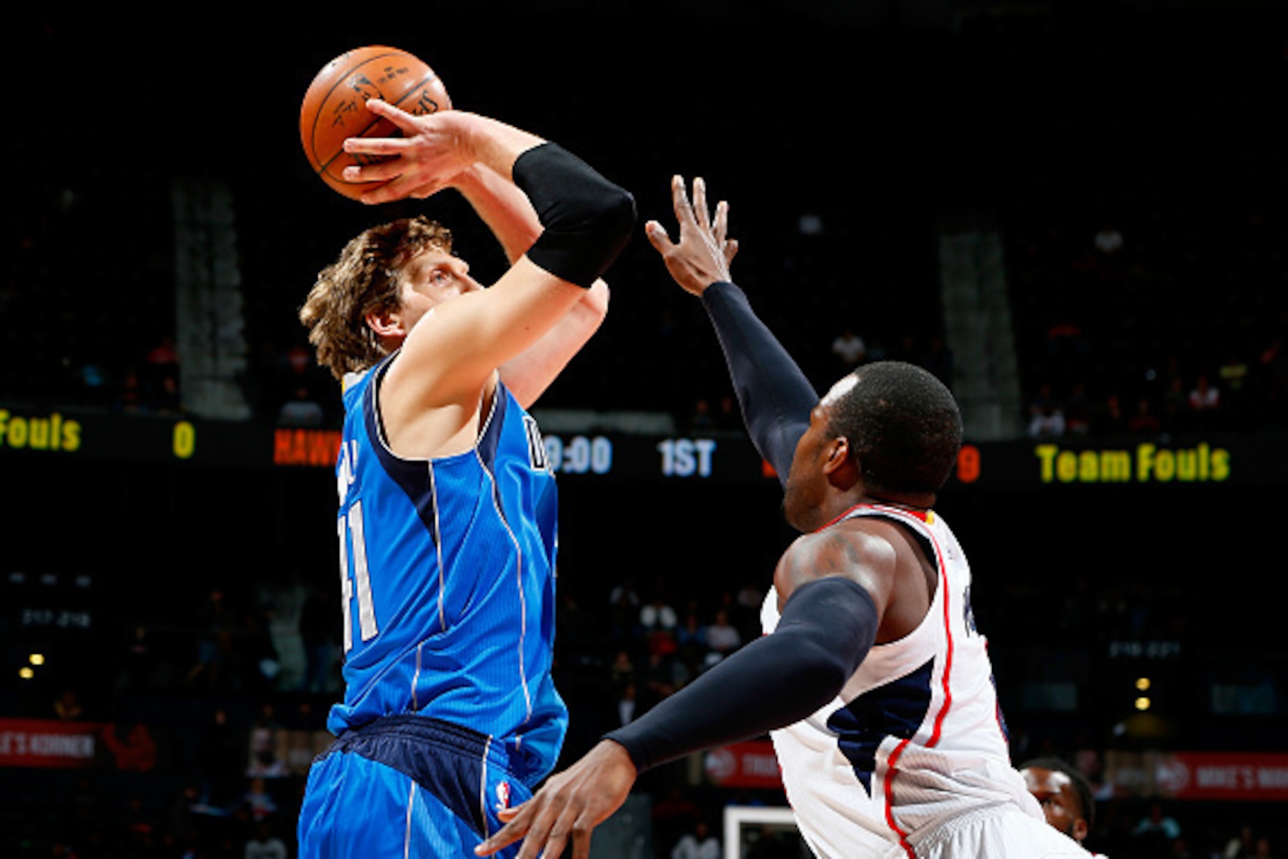 ATLANTA, GA - FEBRUARY 25:  Dirk Nowitzki #41 of the Dallas Mavericks shoots against Paul Millsap #4 of the Atlanta Hawks at Philips Arena on February 25, 2015 in Atlanta, Georgia.  NOTE TO USER: User expressly acknowledges and agrees that, by downloading