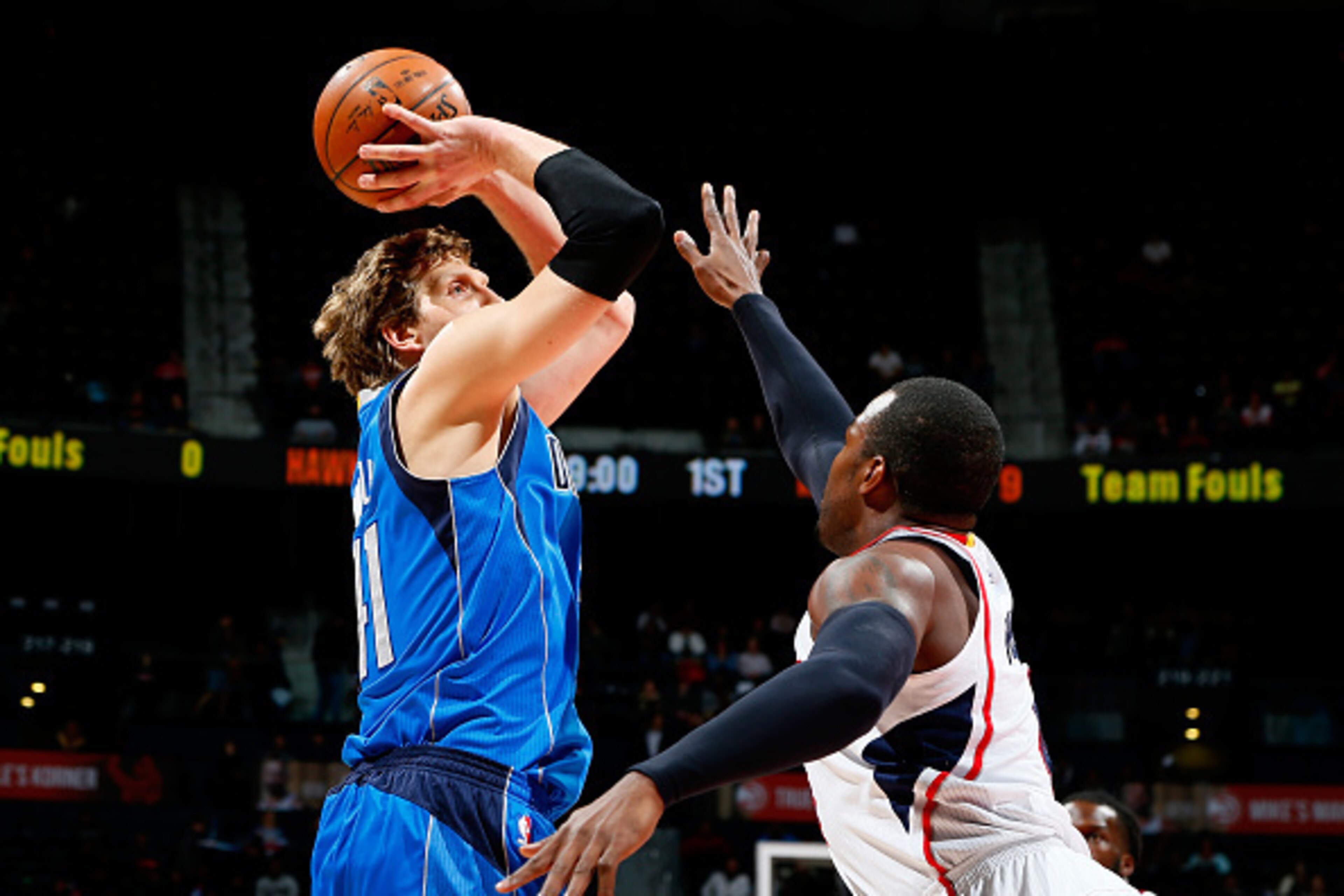 ATLANTA, GA - FEBRUARY 25:  Dirk Nowitzki #41 of the Dallas Mavericks shoots against Paul Millsap #4 of the Atlanta Hawks at Philips Arena on February 25, 2015 in Atlanta, Georgia.  NOTE TO USER: User expressly acknowledges and agrees that, by downloading