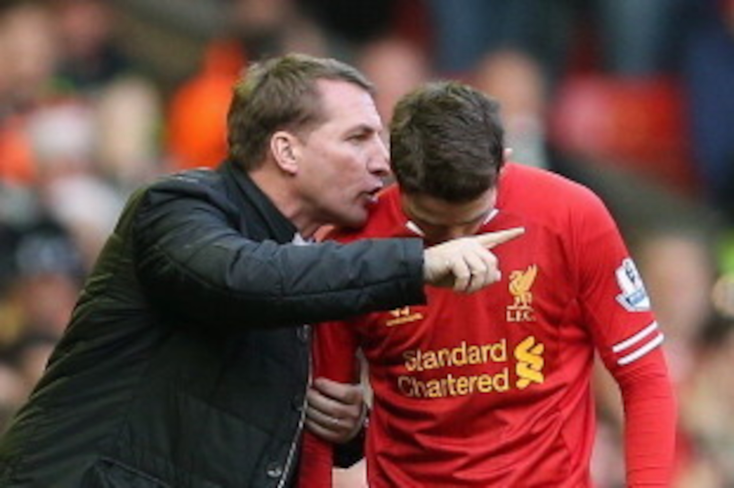 LIVERPOOL, ENGLAND - DECEMBER 21:   Liverpool manager Brendan Rodgers speaks with Joe Allen during the Barclays Premier League match between Liverpool and Cardiff City at Anfield at Anfield on December 21, 2013 in Liverpool, England.  (Photo by Clive Brun