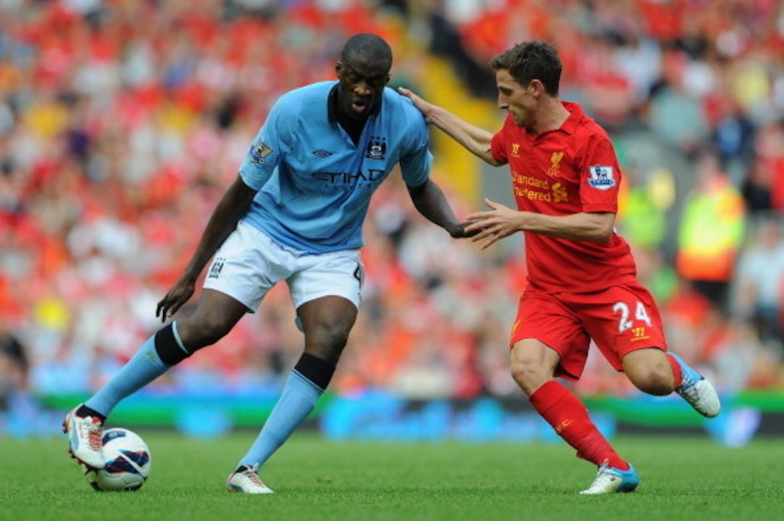 LIVERPOOL, ENGLAND - AUGUST 26:  Yaya Toure of Manchester City competes with Joe Allen of Liverpool during the Barclays Premier League match between Liverpool and Manchester City at Anfield on August 26, 2012 in Liverpool, England.  (Photo by Michael Rega