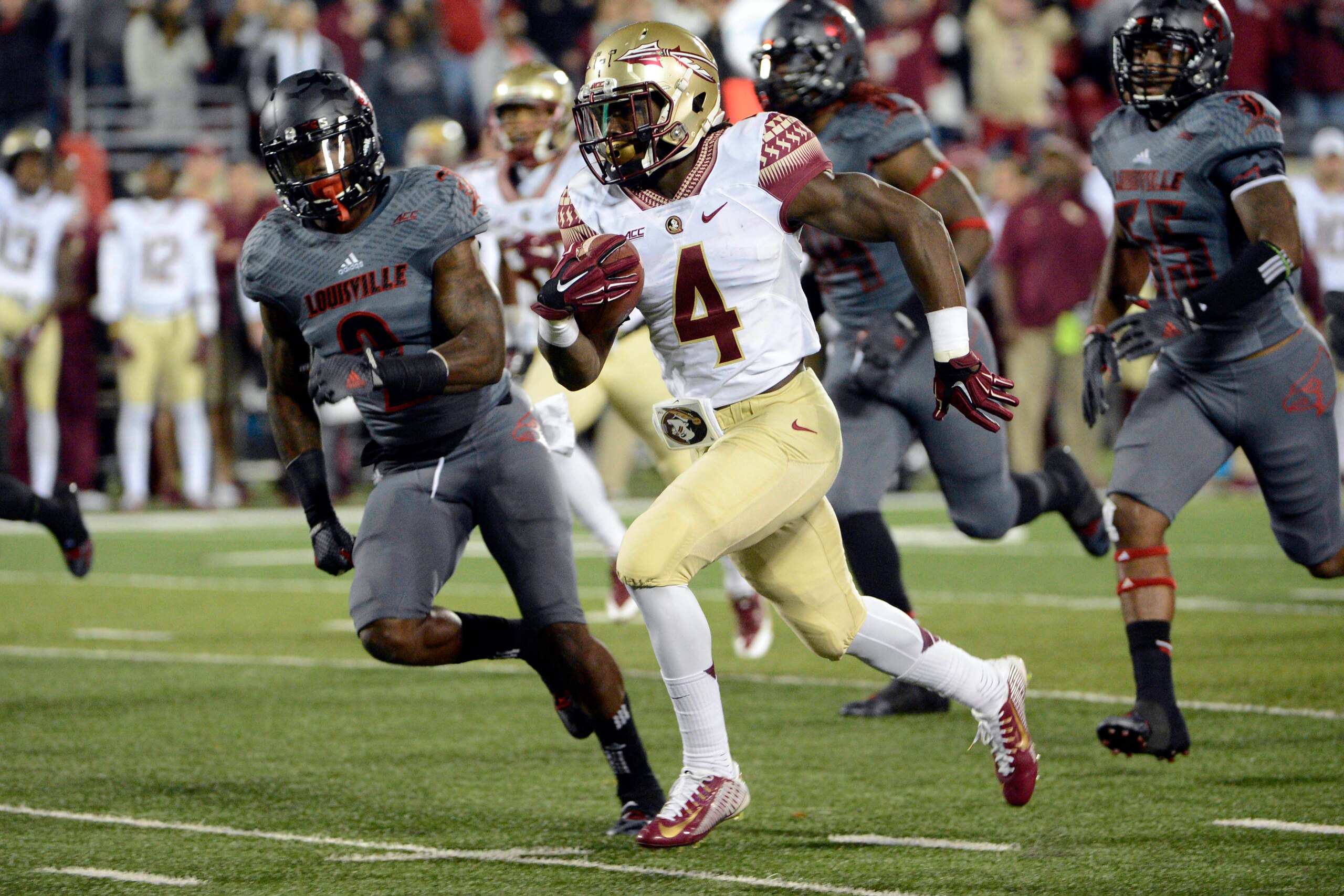 Oct 30, 2014; Louisville, KY, USA; Florida State Seminoles running back Dalvin Cook (4) runs the ball against Louisville Cardinals safety James Sample (2) during the second half at Papa John's Cardinal Stadium. Florida State defeated Louisville 42-31.  Ma