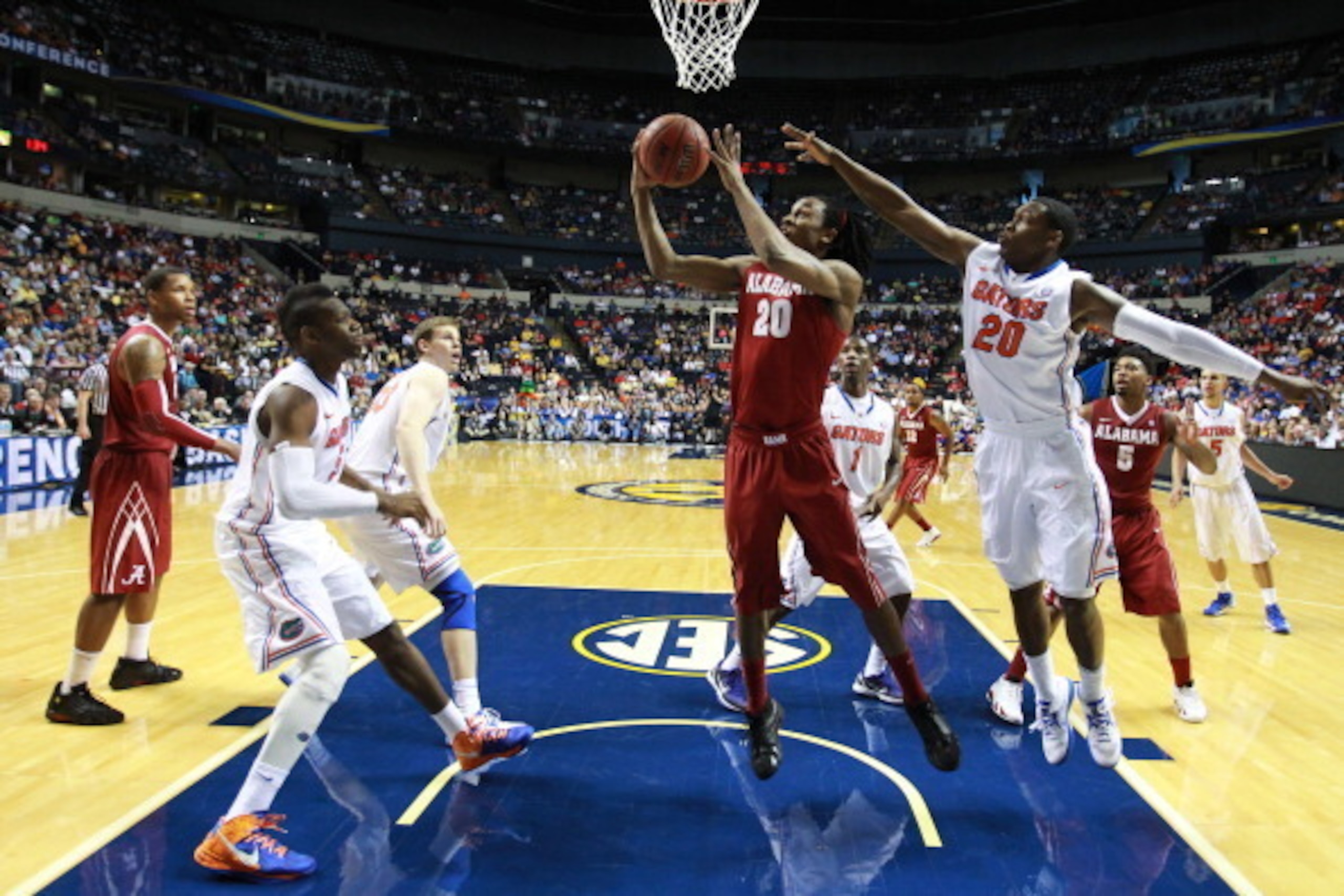 NASHVILLE, TN - MARCH 16:  Levi Randolph #20 of the Alabama Crimson Tide goes up against Michael Frazier II #20 of the Florida Gators during the semifinals of the SEC Baketball Tournament at Bridgestone Arena on March 16, 2013 in Nashville, Tennessee.  (P