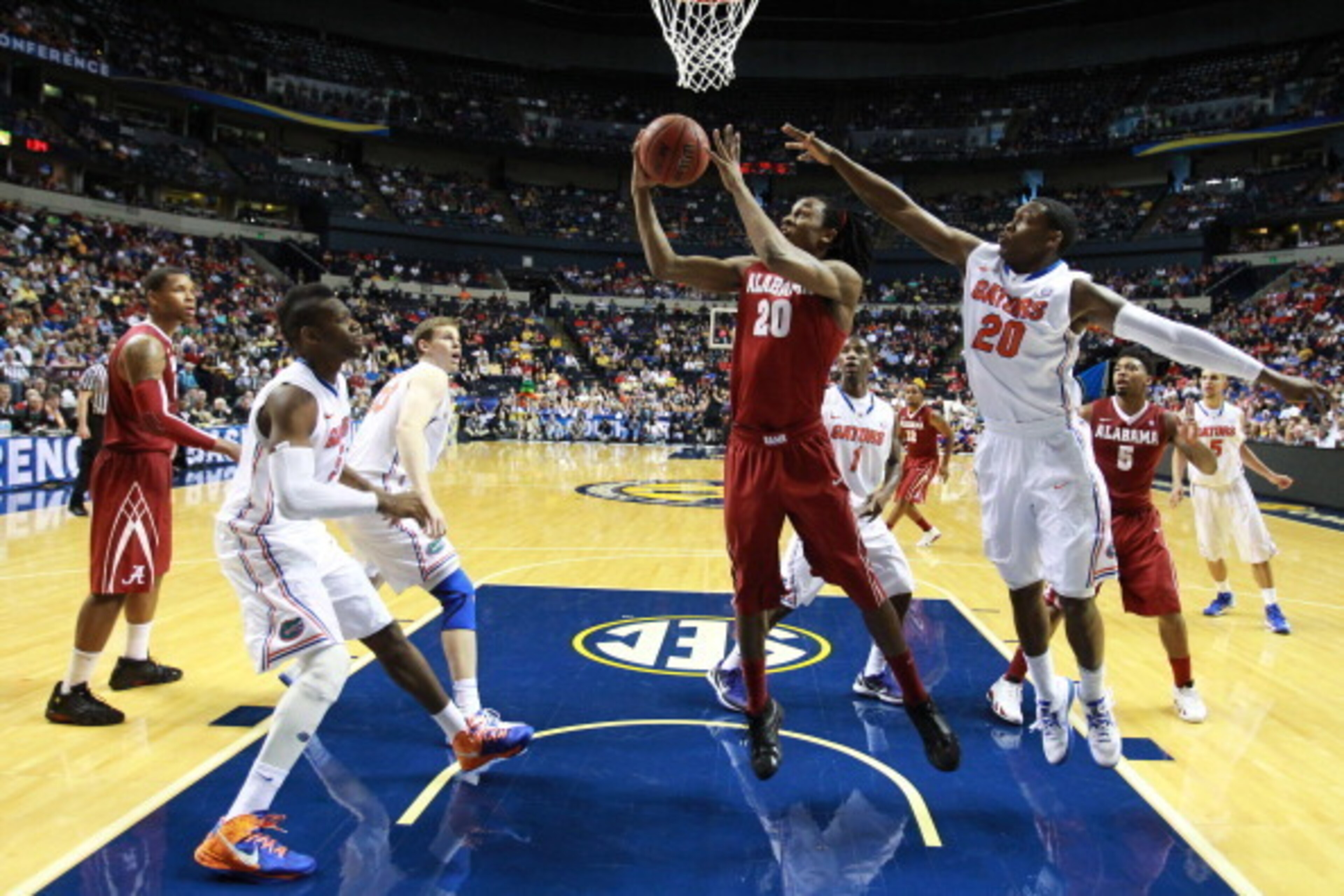 NASHVILLE, TN - MARCH 16:  Levi Randolph #20 of the Alabama Crimson Tide goes up against Michael Frazier II #20 of the Florida Gators during the semifinals of the SEC Baketball Tournament at Bridgestone Arena on March 16, 2013 in Nashville, Tennessee.  (P