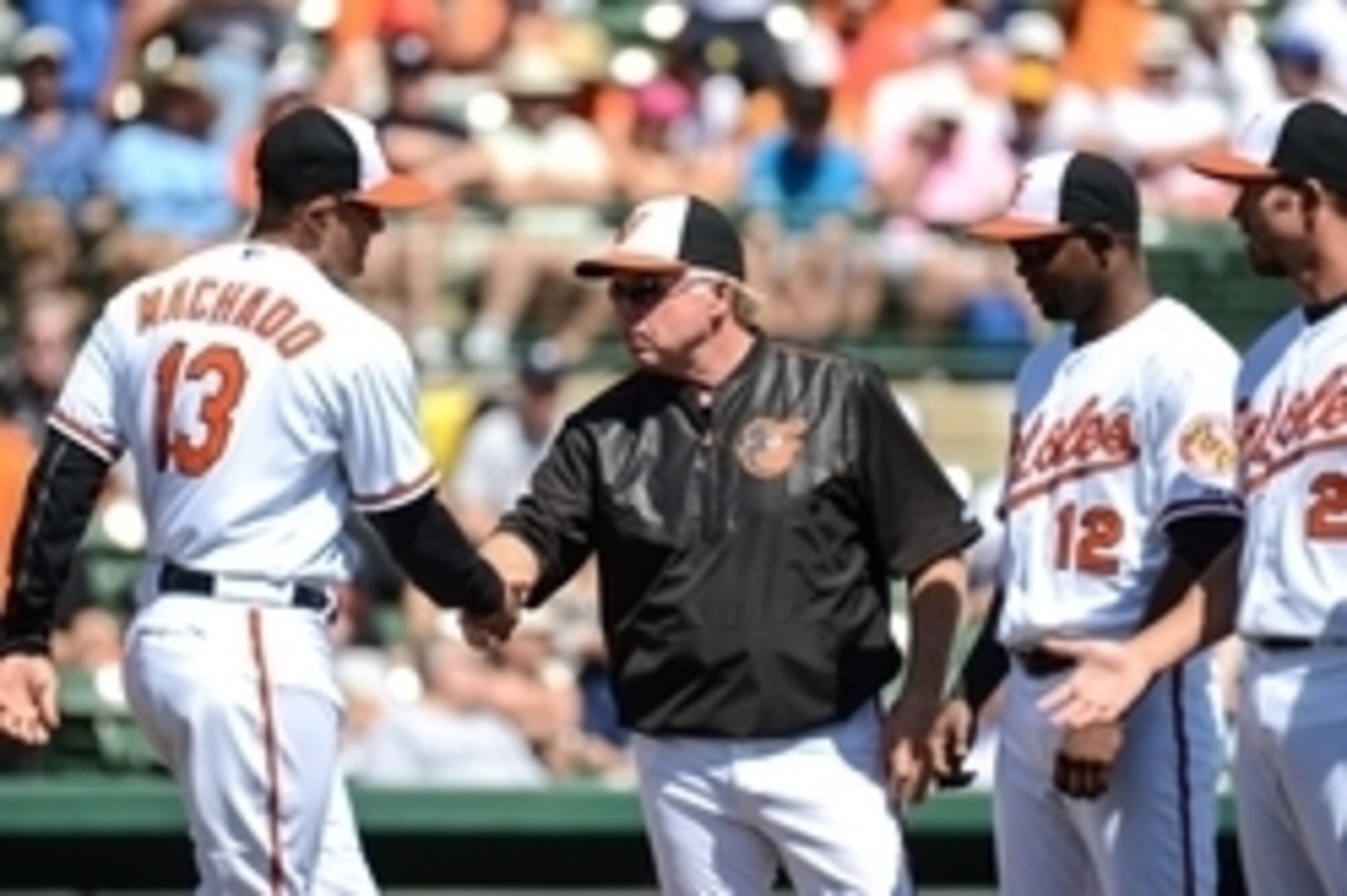 Mar 4, 2015; Sarasota, FL, USA; Baltimore Orioles manager Buck Showalter (26) greets infielder Manny Machado (13) before the start of a spring training baseball game against the Detroit Tigers at Ed Smith Stadium. Mandatory Credit: Jonathan Dyer-USA TODAY