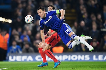 LONDON, ENGLAND - MARCH 11:  John Terry of Chelsea heads the ball clear before it can reach Edinson Cavani of PSG during the UEFA Champions League Round of 16, second leg match between Chelsea and Paris Saint-Germain at Stamford Bridge on March 11, 2015 i