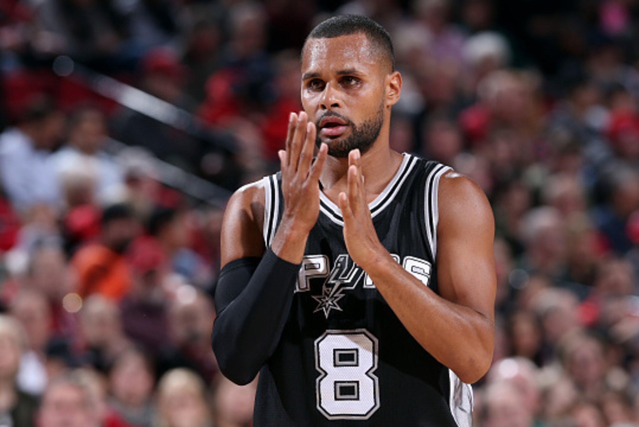 PORTLAND, OR - FEBRUARY 25: Patty Mills #8 of the San Antonio Spurs celebrates during a game against the Portland Trail Blazers on February 25, 2015 at the Moda Center in Portland, Oregon. NOTE TO USER: User expressly acknowledges and agrees that, by down