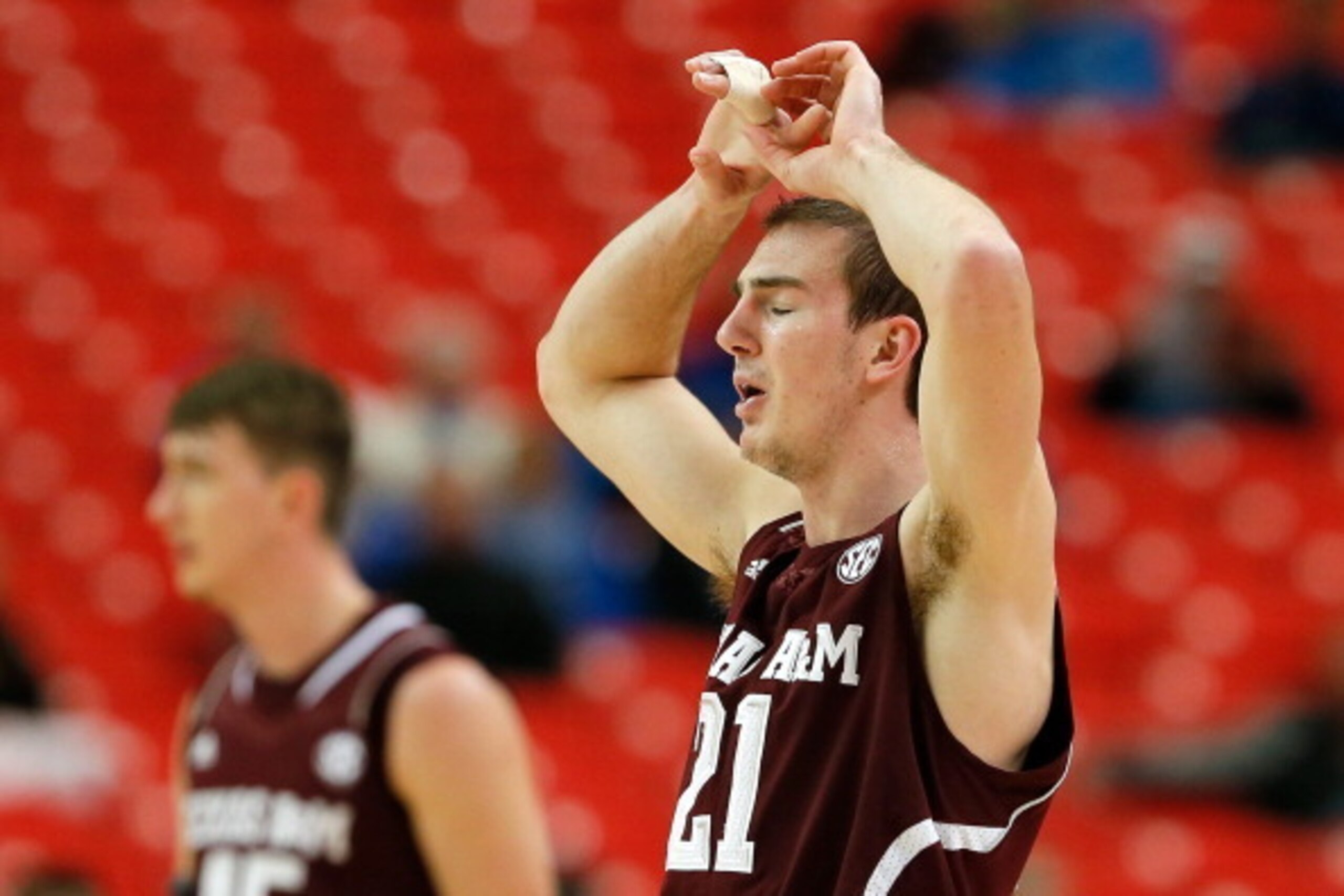 ATLANTA, GA - MARCH 13:  Alex Caruso #21 of the Texas A&M Aggies reacts to a foul in regulation against the Missouri Tigers during the second round of the SEC Men's Basketball Tournament at Georgia Dome on March 13, 2014 in Atlanta, Georgia.  (Photo by Ke