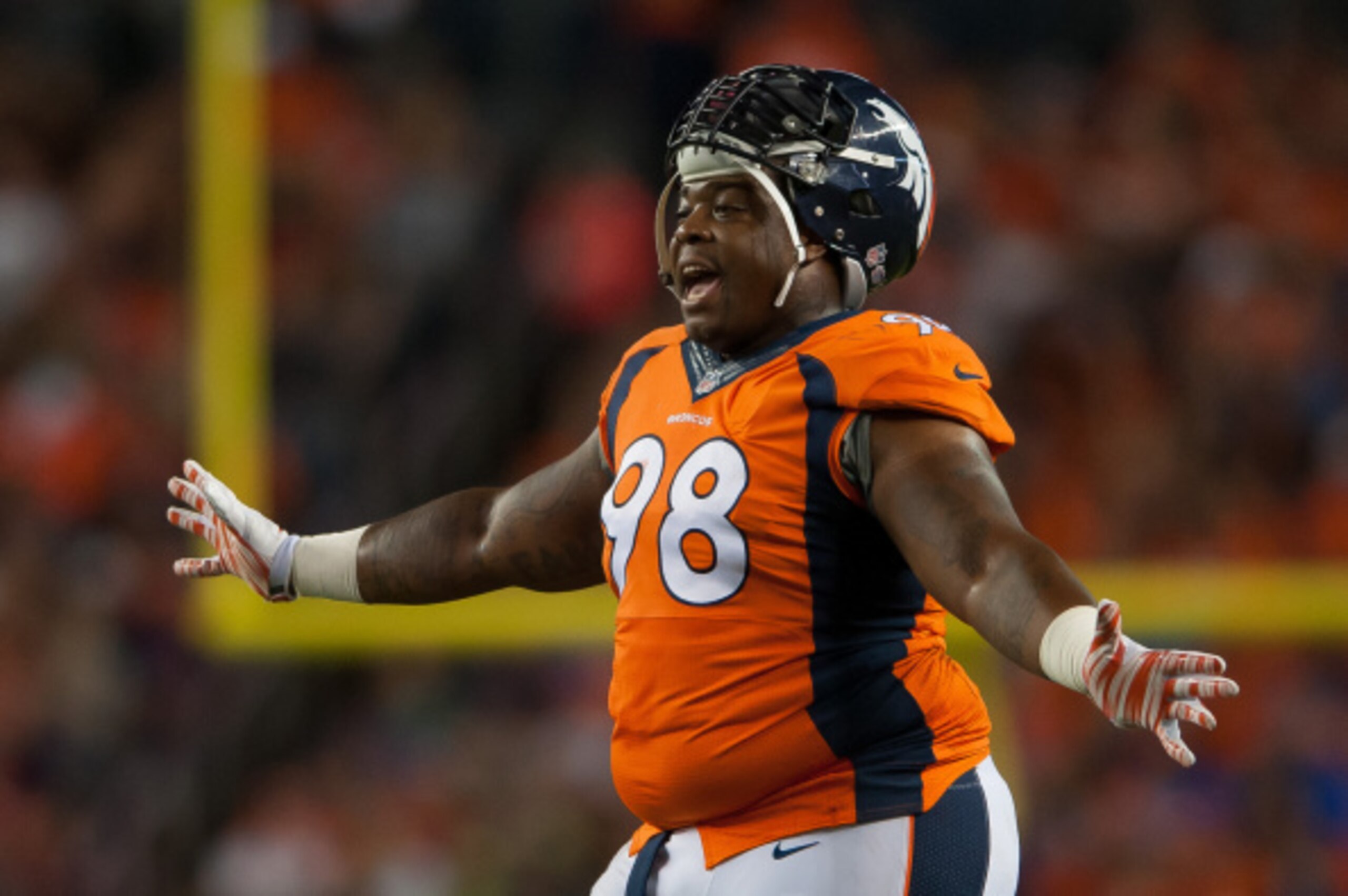 DENVER, CO - AUGUST 07:  Defensive tackle Terrance Knighton #98 of the Denver Broncos talks to teammates during a break in the game against the Seattle Seahawks during preseason action at Sports Authority Field at Mile High on August 7, 2014 in Denver, Co