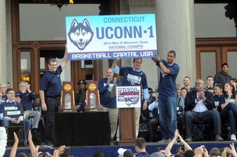 HARTFORD, CT - APRIL 13: Uconn Huskies men's head coache Kevin Ollie (R) and women's head coach Geno Auriemma attend a rally at the Connecticut State Capitol to celebrate their national championships April 13, 2014 in Hartford, Connecticut. This year was 