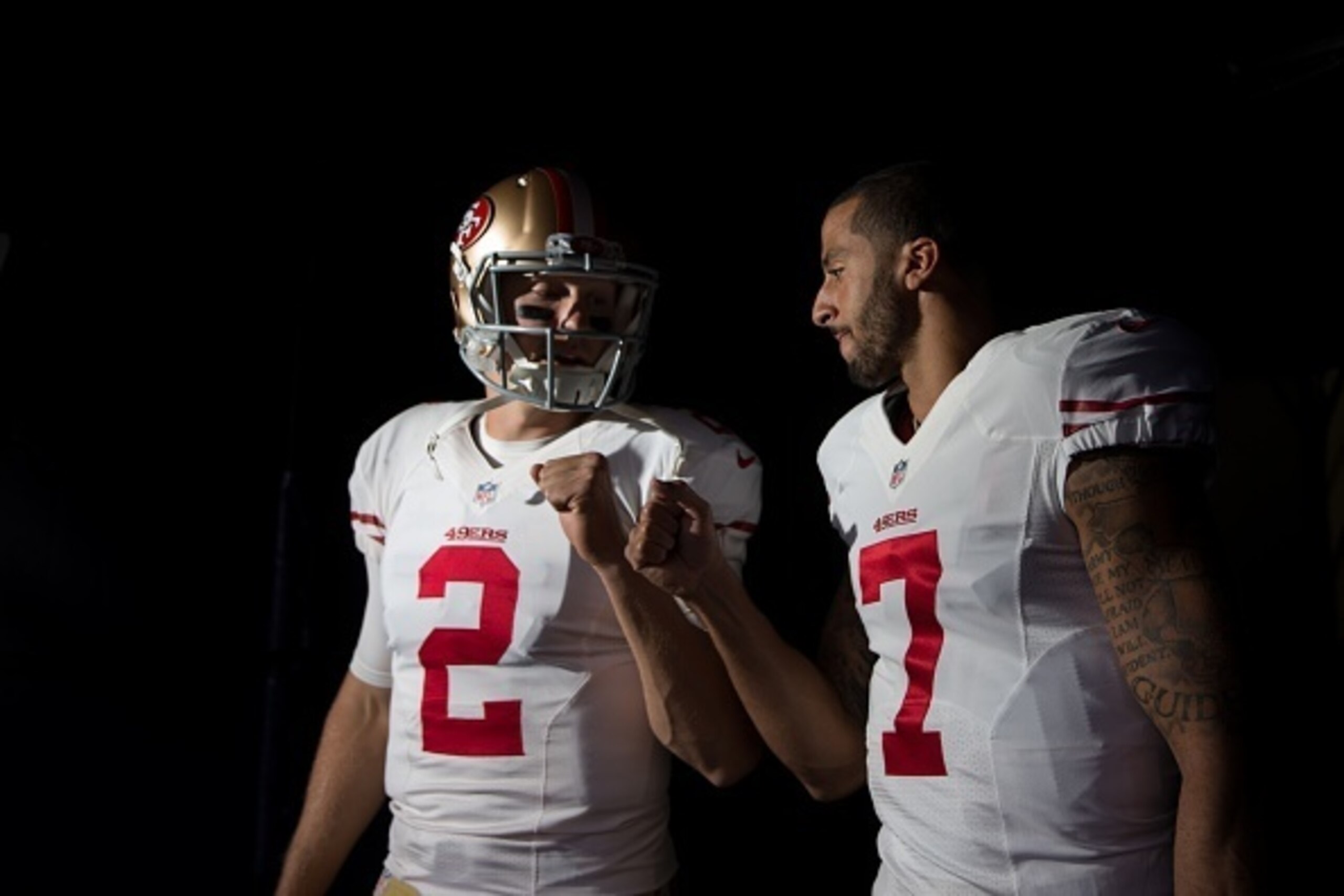 DENVER, CO - OCTOBER 19: Quarterback Colin Kaepernick #7 and quarterback Blaine Gabbert #2 of the San Francisco 49ers bump fists before emerging from the visiting tunnel before a game against the Denver Broncos at Sports Authority Field at Mile High on Oc