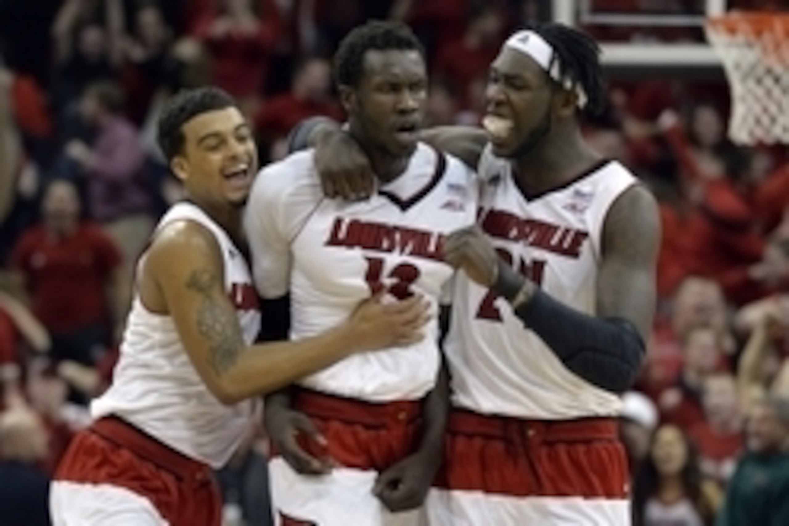 Mar 7, 2015; Louisville, KY, USA; Louisville Cardinals guard Quentin Snider (2) and forward Montrezl Harrell (24) celebrate with Cardinals forward/center Mangok Mathiang (12) after taking the lead against the Virginia Cavaliers during the second half at K