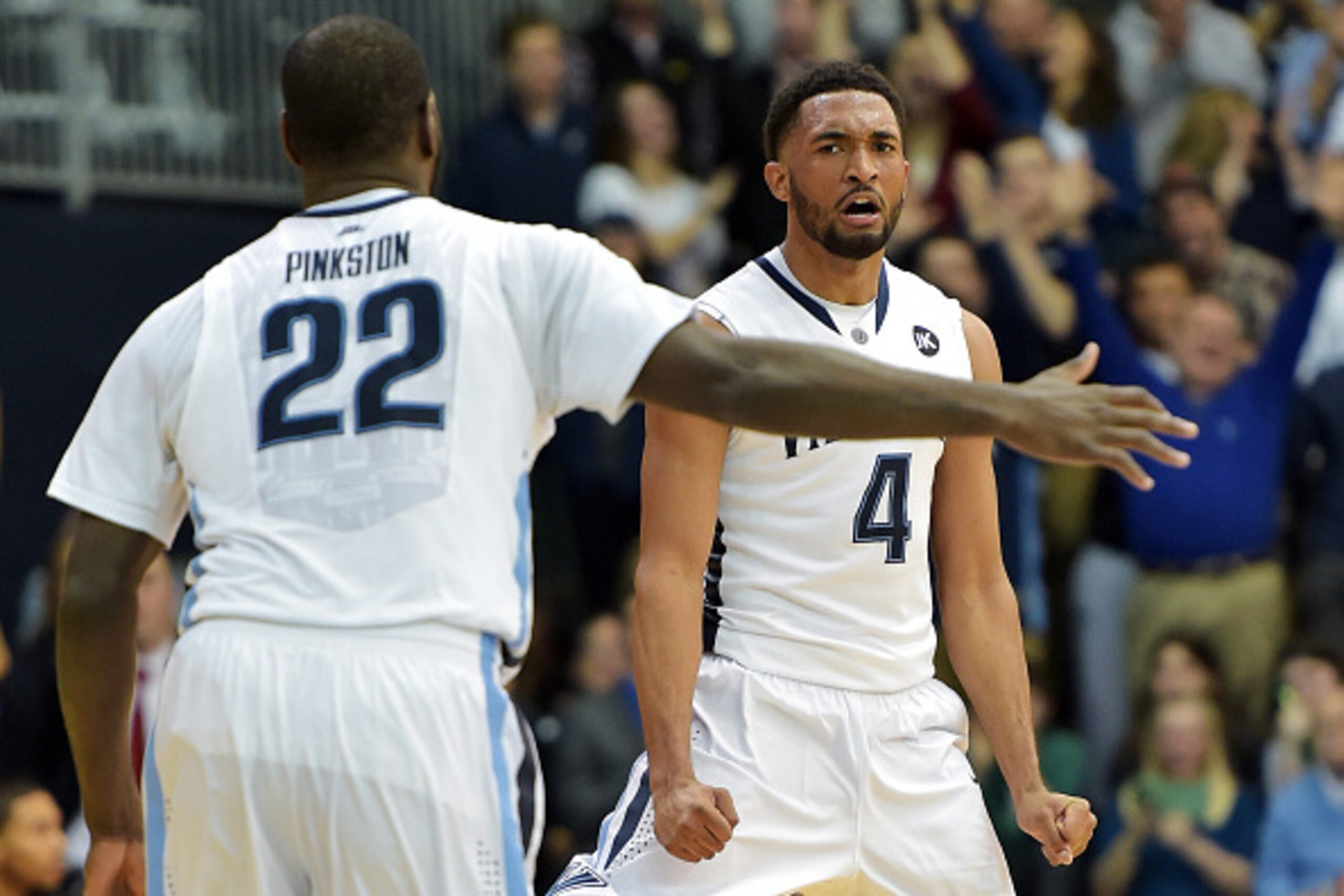 VILLANOVA, PA - FEBRUARY 24: Darrun Hilliard #4 of the Villanova Wildcats celebrates a three point shot as teammate JayVaughn Pinkston #22 congratulates him against the Providence Friars at The Pavilion on February 24, 2015 in Villanova, Pennsylvania. Vil