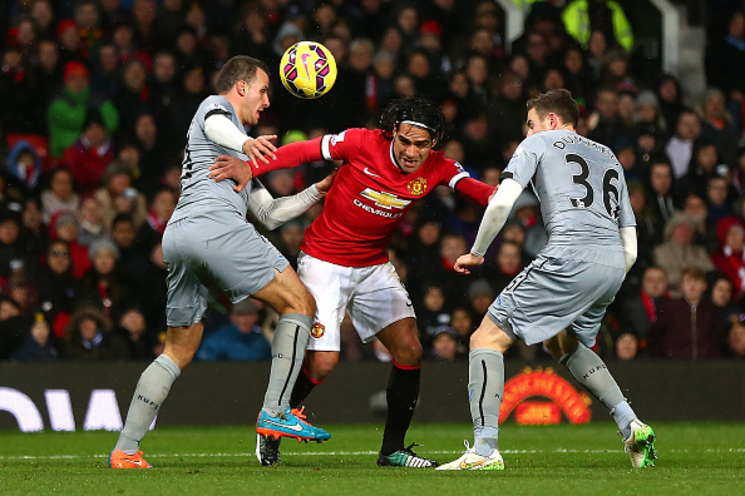 MANCHESTER, ENGLAND - DECEMBER 26: Radamel Falcao of Manchester United is challenged by Steven Taylor (L) and Paul Dummett of Newcastle United the Barclays Premier League match between Manchester United and Newcastle United at Old Trafford on December 26 MANCHESTER, ENGLAND - DECEMBER 26: Radamel Falcao of Manchester United is challenged by Steven Taylor (L) and Paul Dummett of Newcastle United the Barclays Premier League match between Manchester United and Newcastle United at Old Trafford on December 26