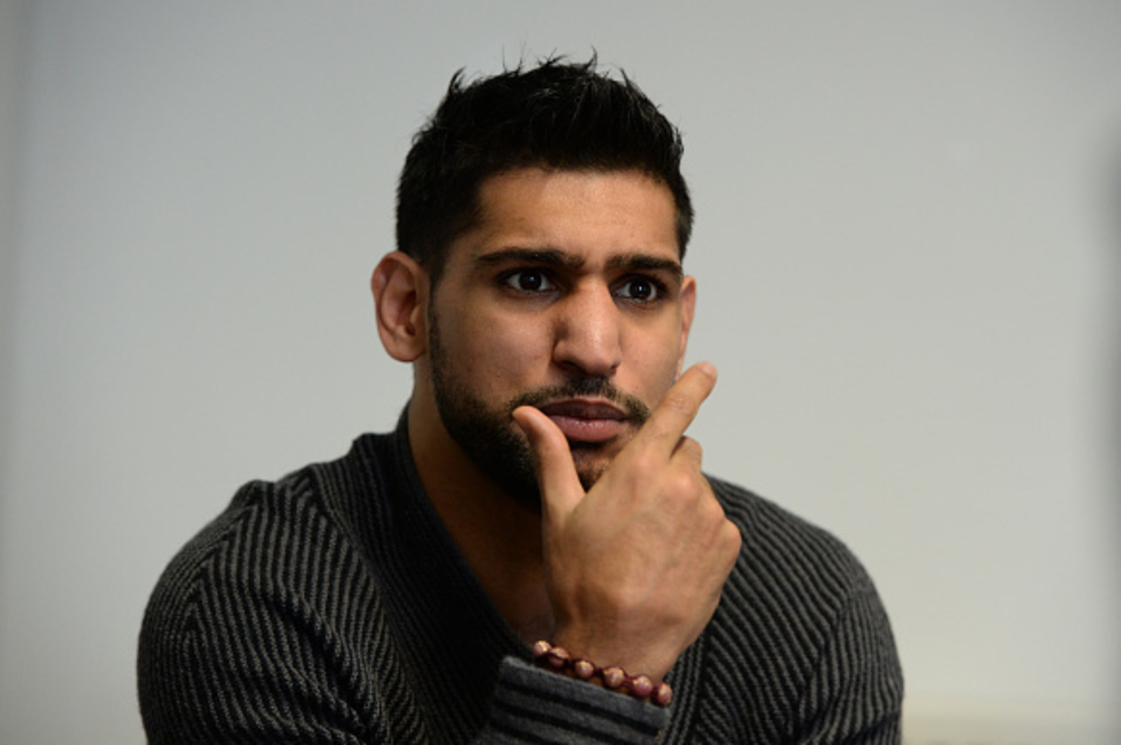 SHEFFIELD, ENGLAND - FEBRUARY 19:  Boxer Amir Khan speaks to media during a visit to Fight Label who make his shorts on February 19, 2015 in Sheffield, England.  (Photo by Nigel Roddis/Getty Images)